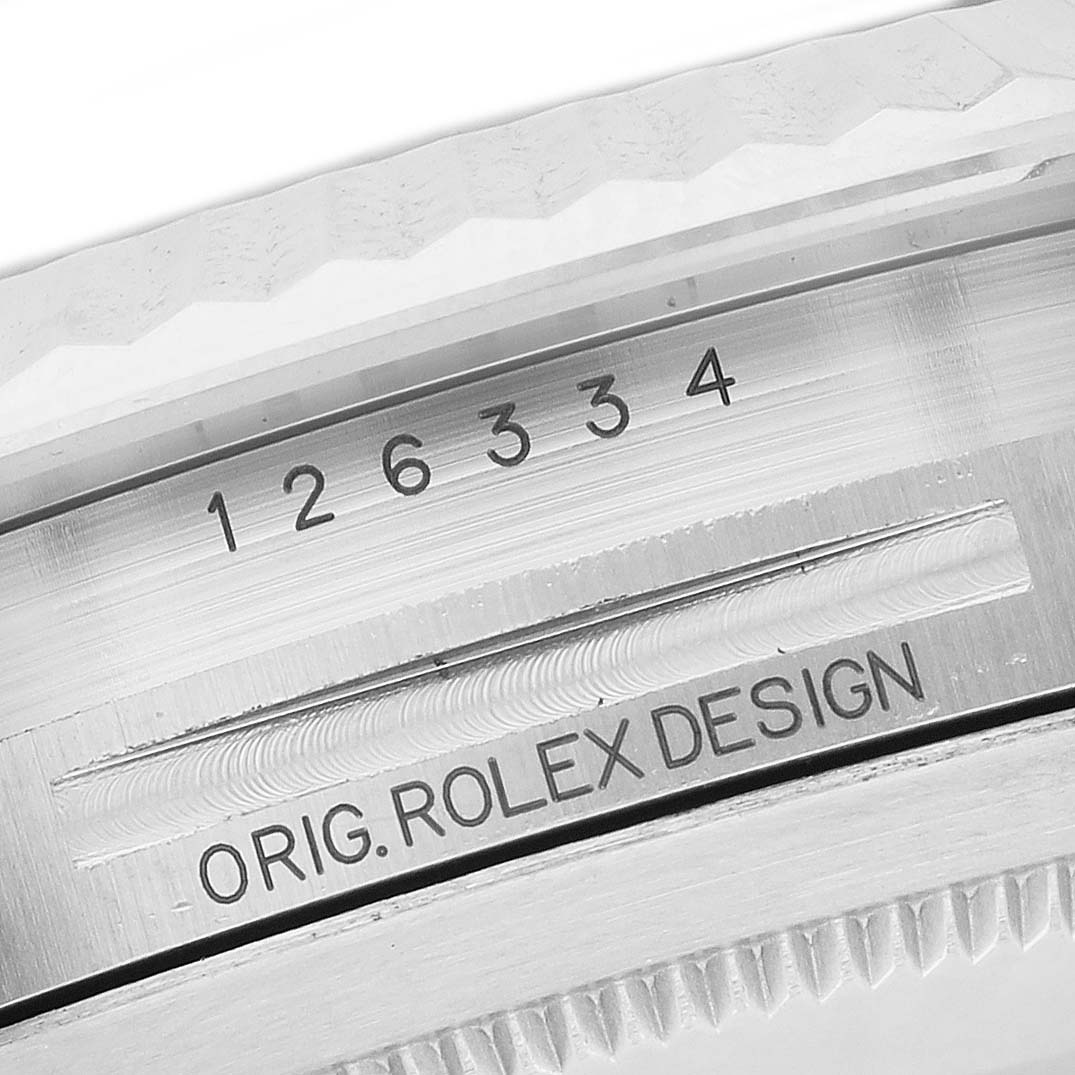 The image shows a close-up of the case side, bezel edge, and engravings on a Rolex Datejust 41 126334 Men's Stainless Steel Green Dial.