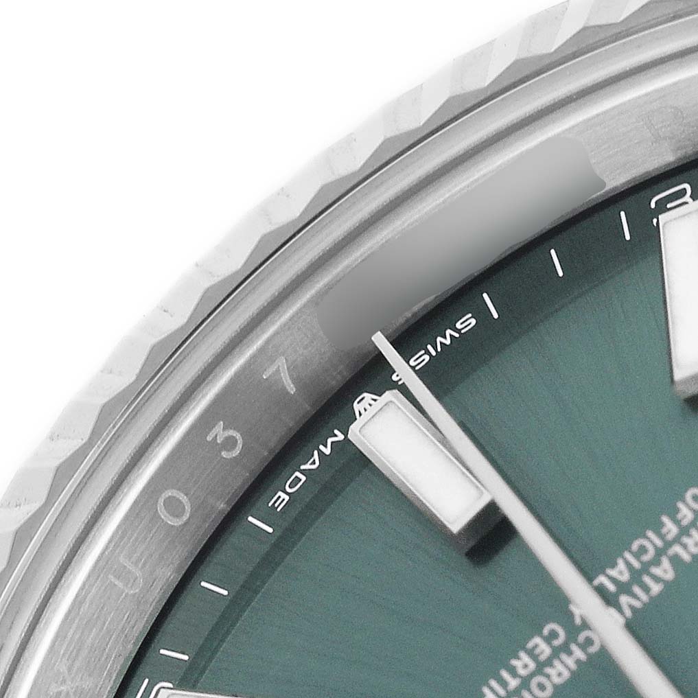 The image shows a close-up of the Rolex Datejust 41 126334 Men's Stainless Steel Green Dial, highlighting the dial, date window, and part of the fluted bezel.