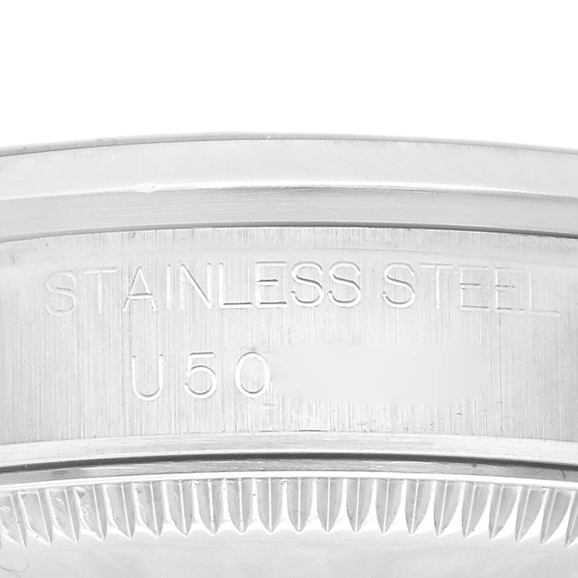 This close-up image of the Mid-Size Rolex watch shows a section of the case with the "STAINLESS STEEL" engraving and part of the serial number.
