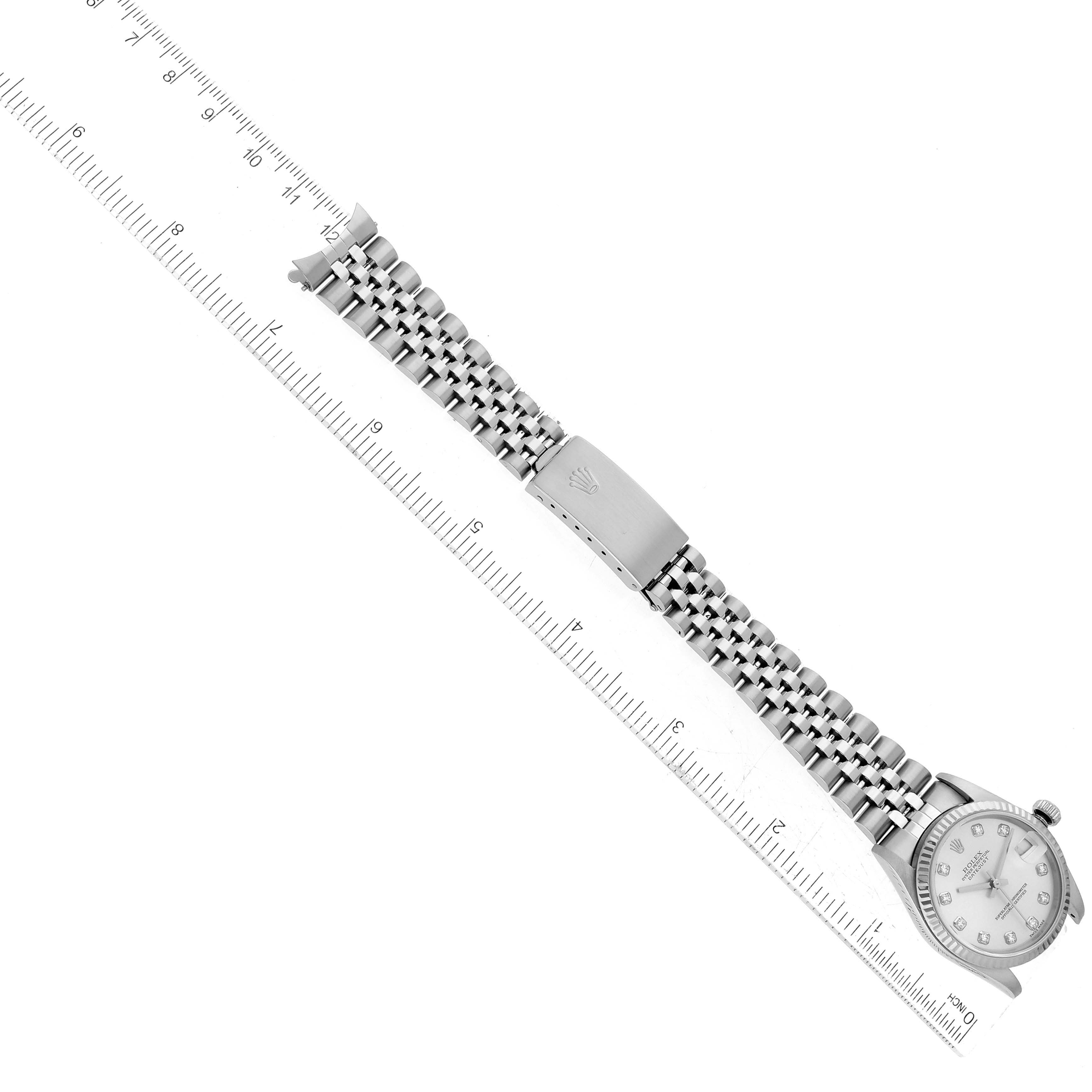 The image shows a top-down view of a Rolex Mid-Size 78274 Women's Stainless Steel Silver Dial 78274 Women's Stainless Steel Silver Dial model watch, displaying the entire band and dial alongside a ruler for scale.