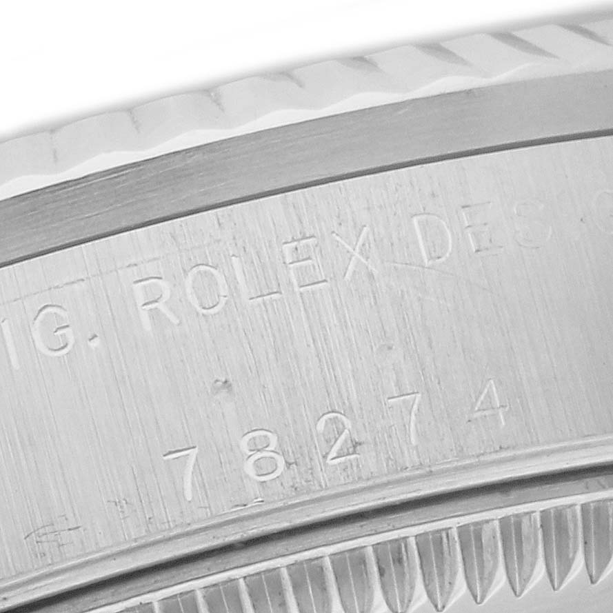 Close-up of the case side, showing the engraved serial number and part of the bezel of the Rolex Mid-Size 78274 Women's Stainless Steel Silver Dial 78274 Women's Stainless Steel Silver Dial model.