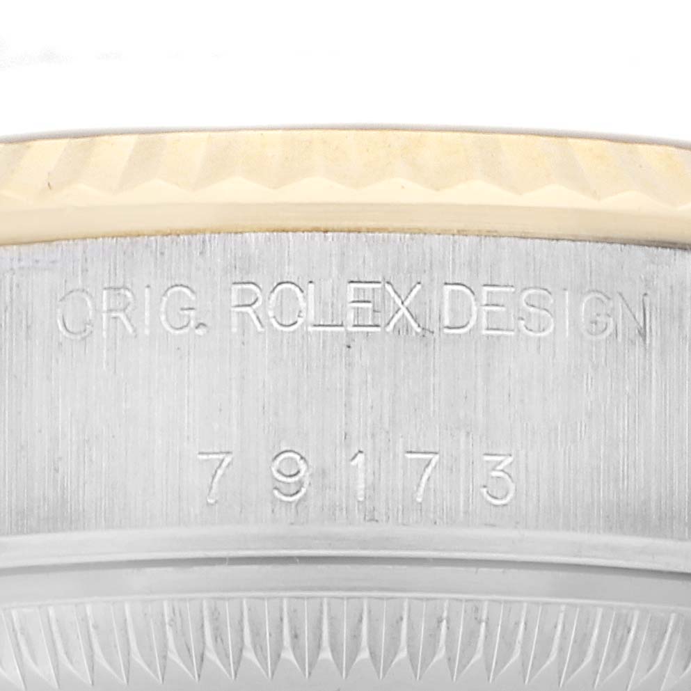 The image shows an angled close-up of the case side of a Rolex Datejust model 79173, highlighting the "ORIG. ROLEX DESIGN" engraving and the model number 79173.