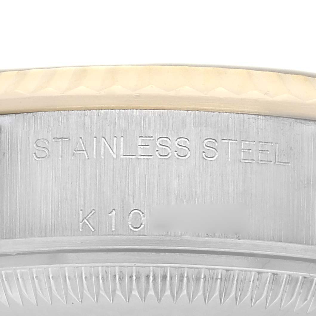 The image shows a close-up of the side of a Rolex Datejust, model 79173, featuring the "STAINLESS STEEL" engraving and part of the fluted bezel.