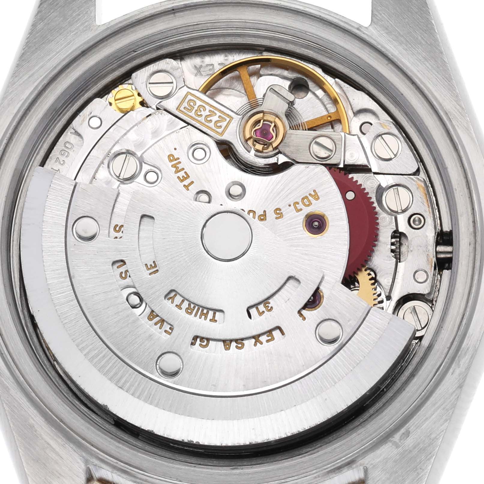 The image shows the movement of a Rolex Datejust model 79173 men's watch, viewed from the back, highlighting the intricate inner mechanics and rotor.