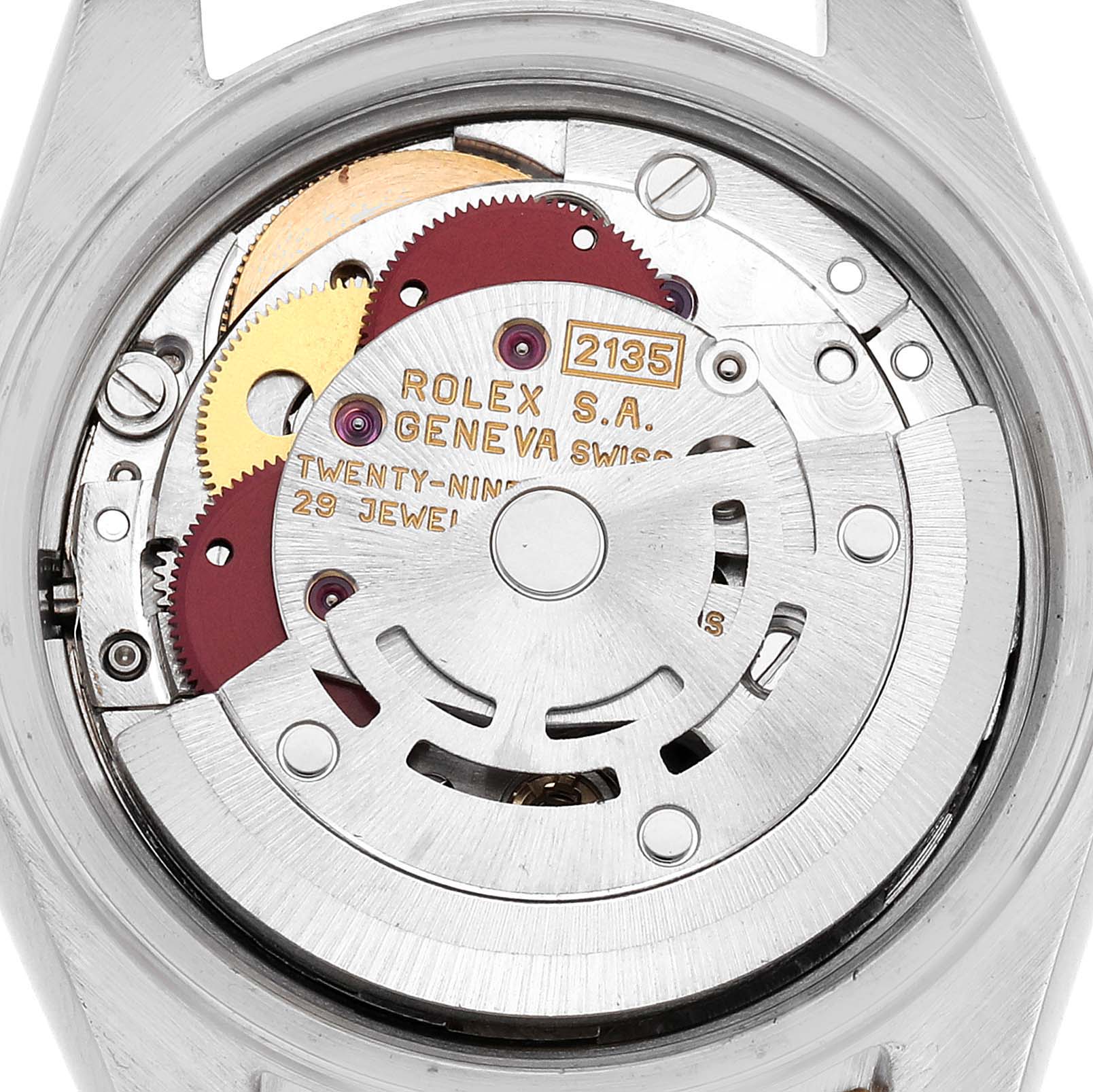 The image shows the movement of a Rolex Datejust watch, model number 69173, viewed from the back, revealing the intricate gears and rotor mechanism.