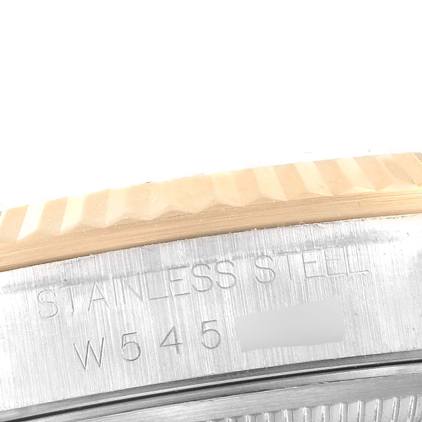 The image shows a close-up of the fluted bezel and part of the caseback of a Rolex Datejust 16233 Men's Steel and Gold (two tone) Blue Dial 16233 Men's Steel and Gold (two tone) Blue Dial watch with "STAINLESS STEEL" engraved.
