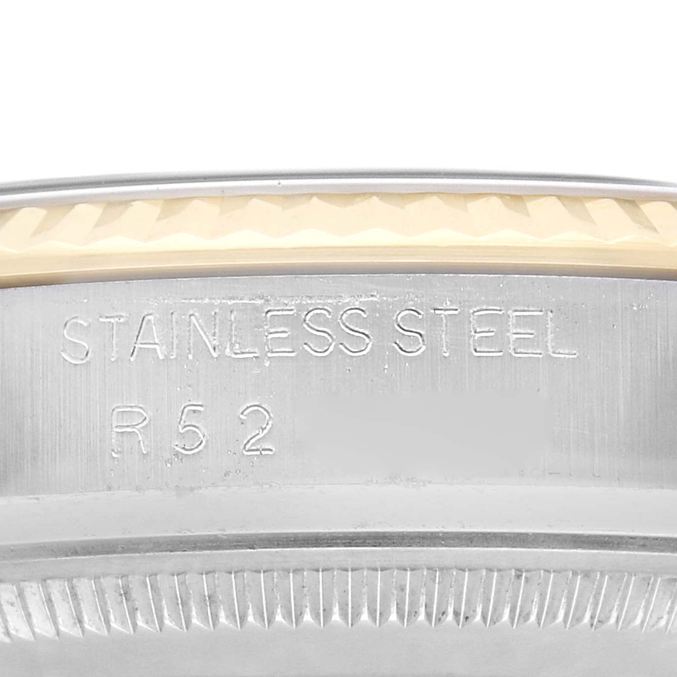 The image shows a close-up angle of the case back edge and part of the bezel of the Rolex Vintage Collection model 16013 Men's watch, highlighting the "STAINLESS STEEL" engraving.
