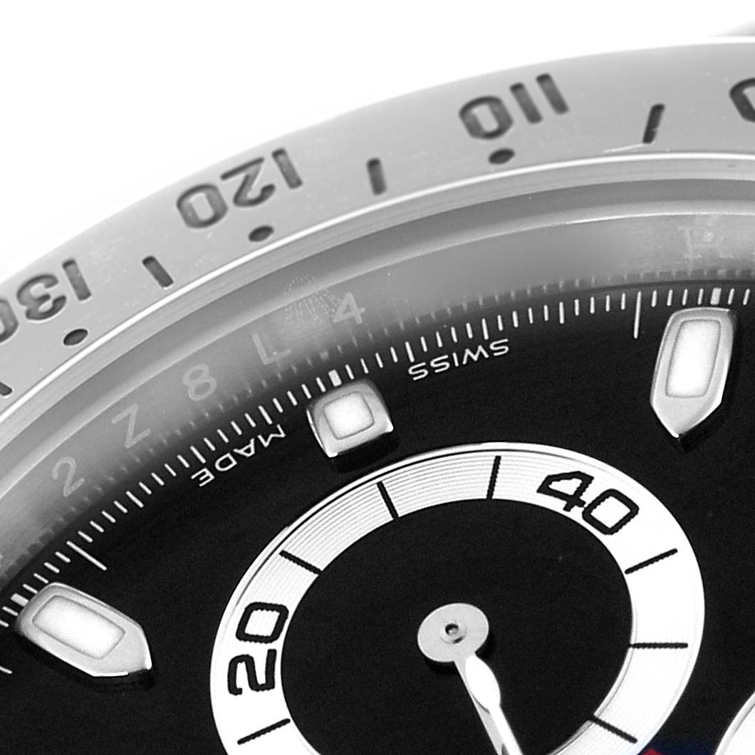 The image shows a close-up of the dial and bezel of the Rolex Daytona model 116520, focusing on the hour markers and subdial.