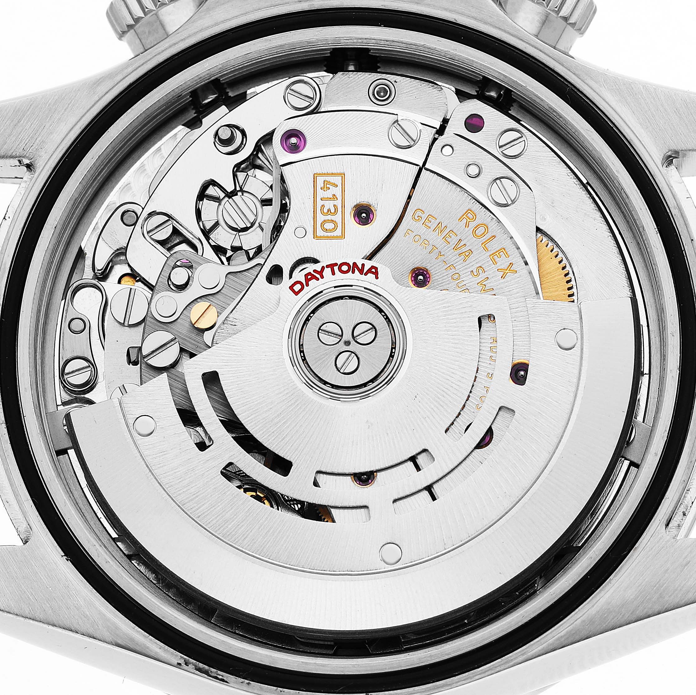 The image shows the intricate movement of a Rolex Daytona 116520 Men's Stainless Steel White Dial watch viewed from the back, displaying its internal mechanics.