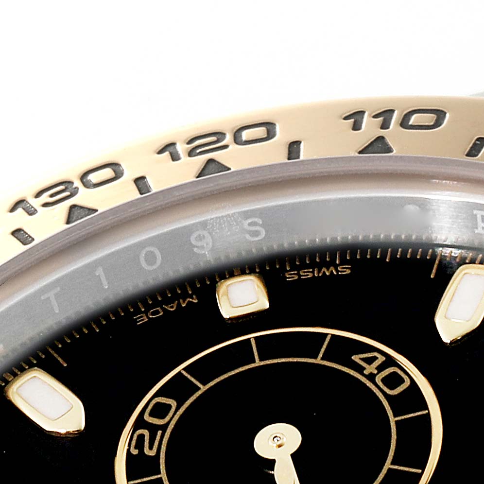 The image shows a close-up of the bezel and top part of the dial of a Rolex Daytona 116503 Men's Steel and Gold (two tone) Black Dial 116503 Men's Steel and Gold (two tone) Black Dial watch.