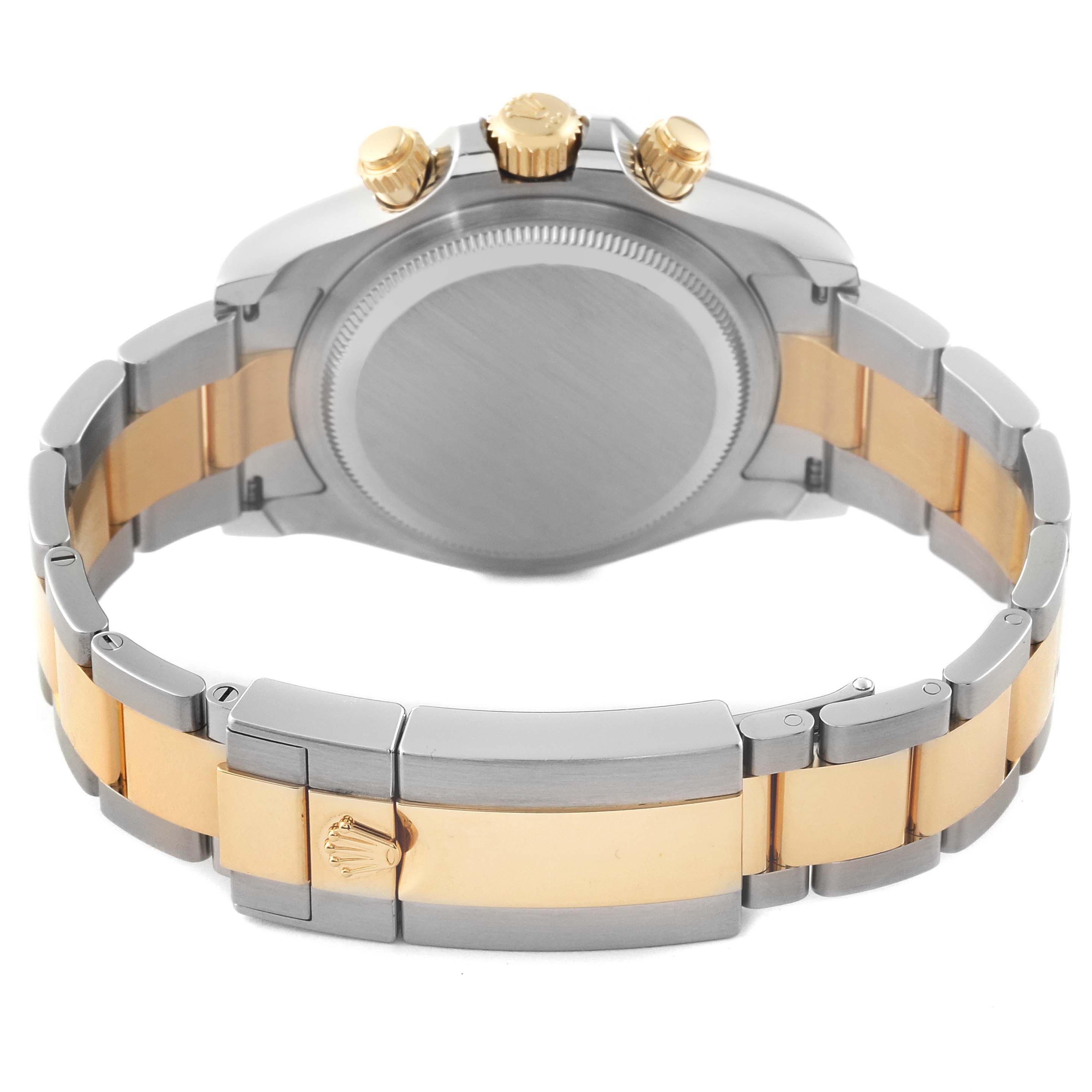 This image shows the back, the winding crown, and push buttons of a Rolex Daytona 126503 Men's Steel and Gold (two tone) Black Dial 126503 Men's Steel and Gold (two tone) Black Dial watch, highlighting its two-tone bracelet.