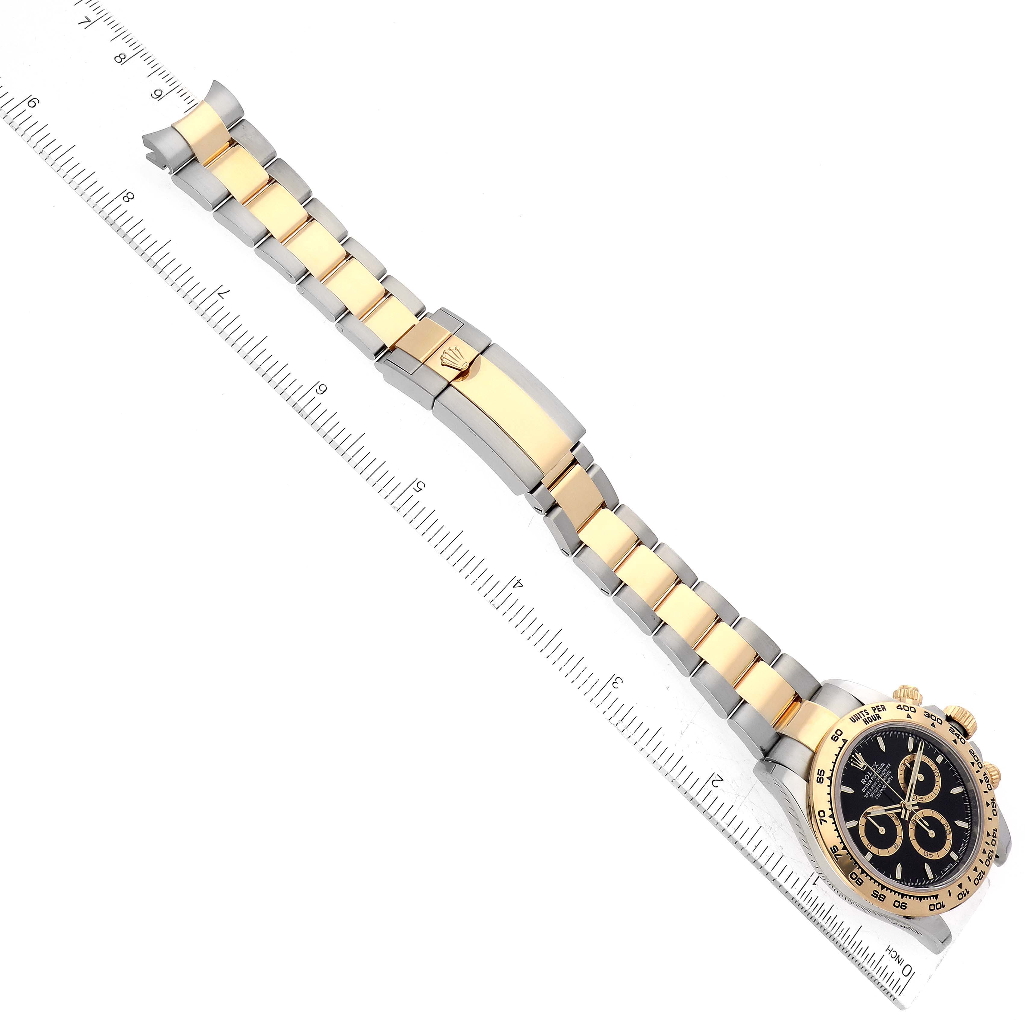 The image shows a Rolex Daytona 126503 Men's Steel and Gold (two tone) Black Dial 126503 Men's Steel and Gold (two tone) Black Dial watch placed diagonally with a close-up of the bracelet and clasp, alongside a ruler for scale.