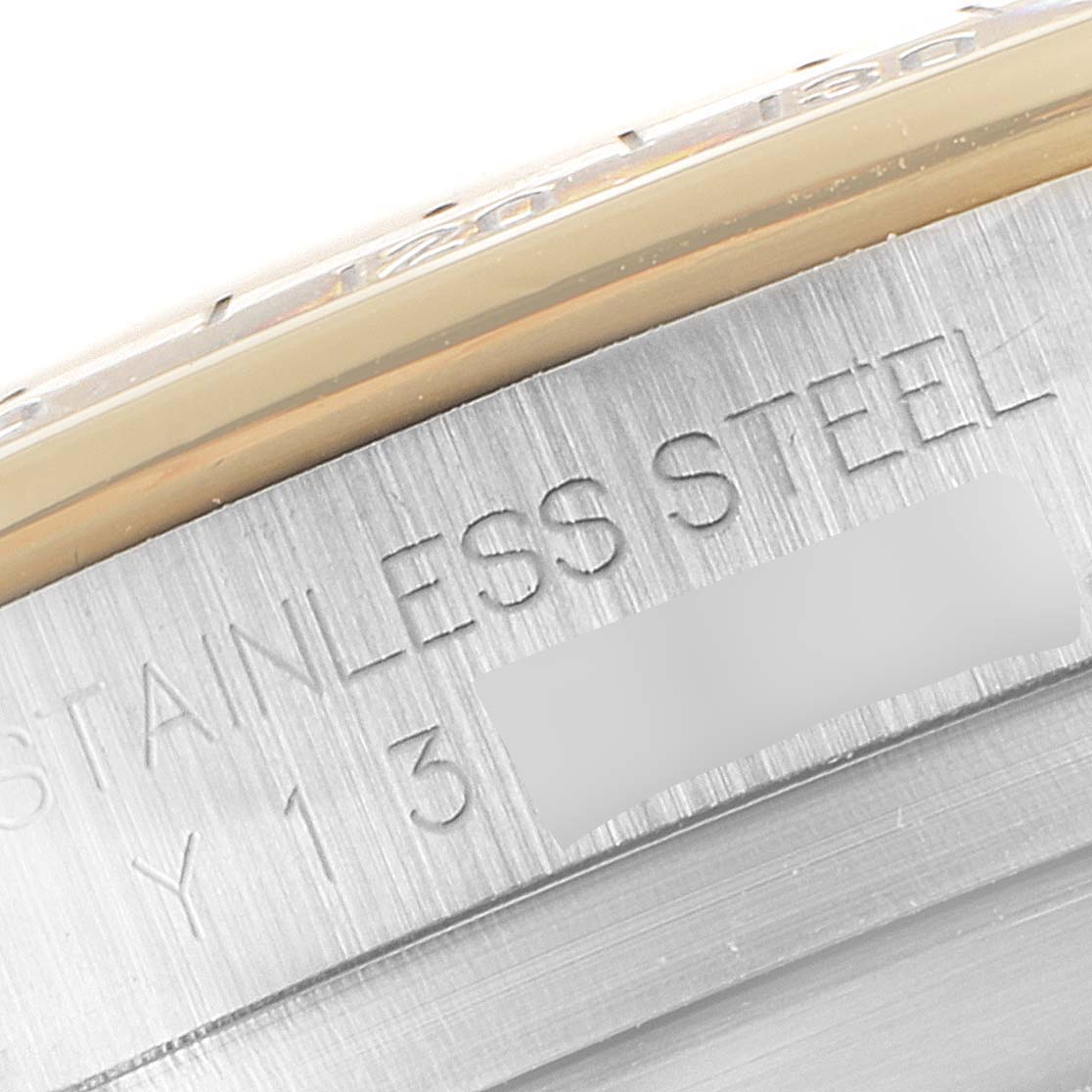 This image shows a close-up of the case back of a Rolex Daytona 116523 Men
s Steel and Gold (two tone) Black Dial 116523 Men
s Steel and Gold (two tone) Black Dial, highlighting the "STAINLESS STEEL" engraving.