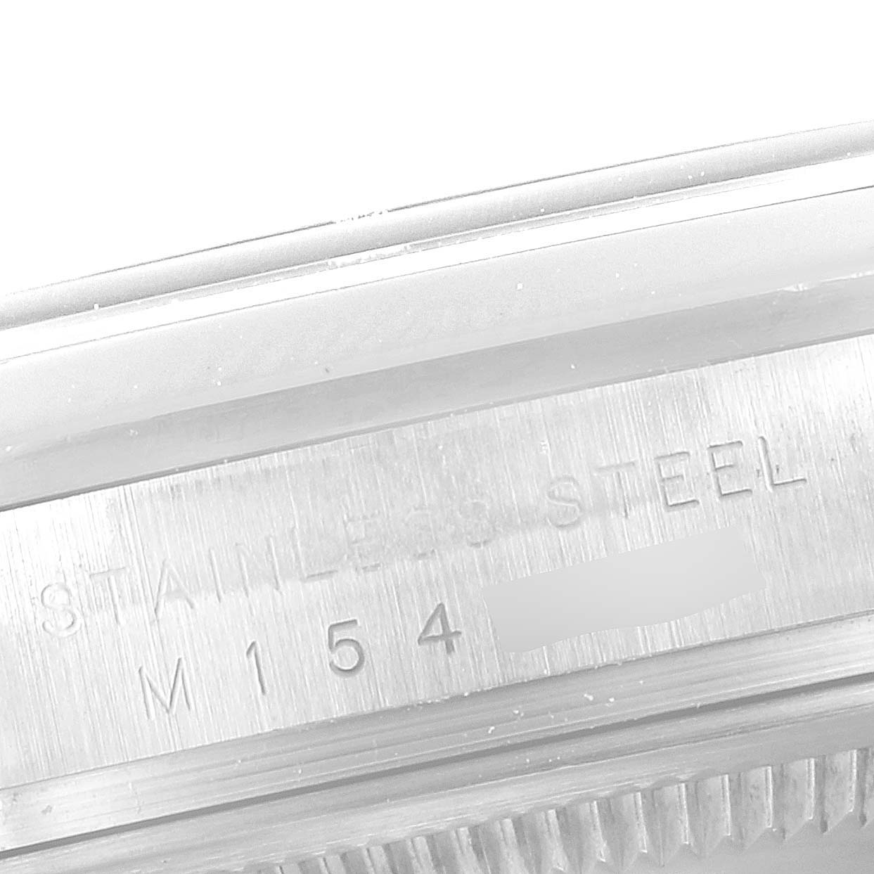 This image shows the engraving on the stainless steel case of a Rolex Explorer 114270 Men's Stainless Steel Black Dial 114270 Men's Stainless Steel Black Dial watch, including part of its serial number.