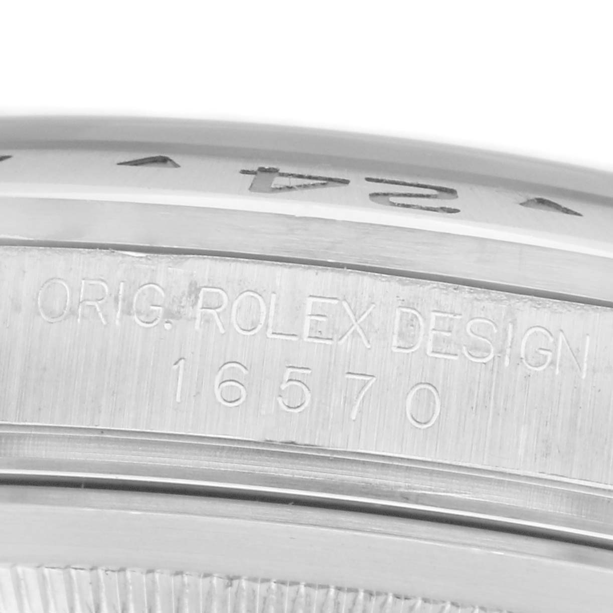 The image shows a close-up angle of the side of a Rolex Explorer, model number 16570, featuring the engraved design and model number.
