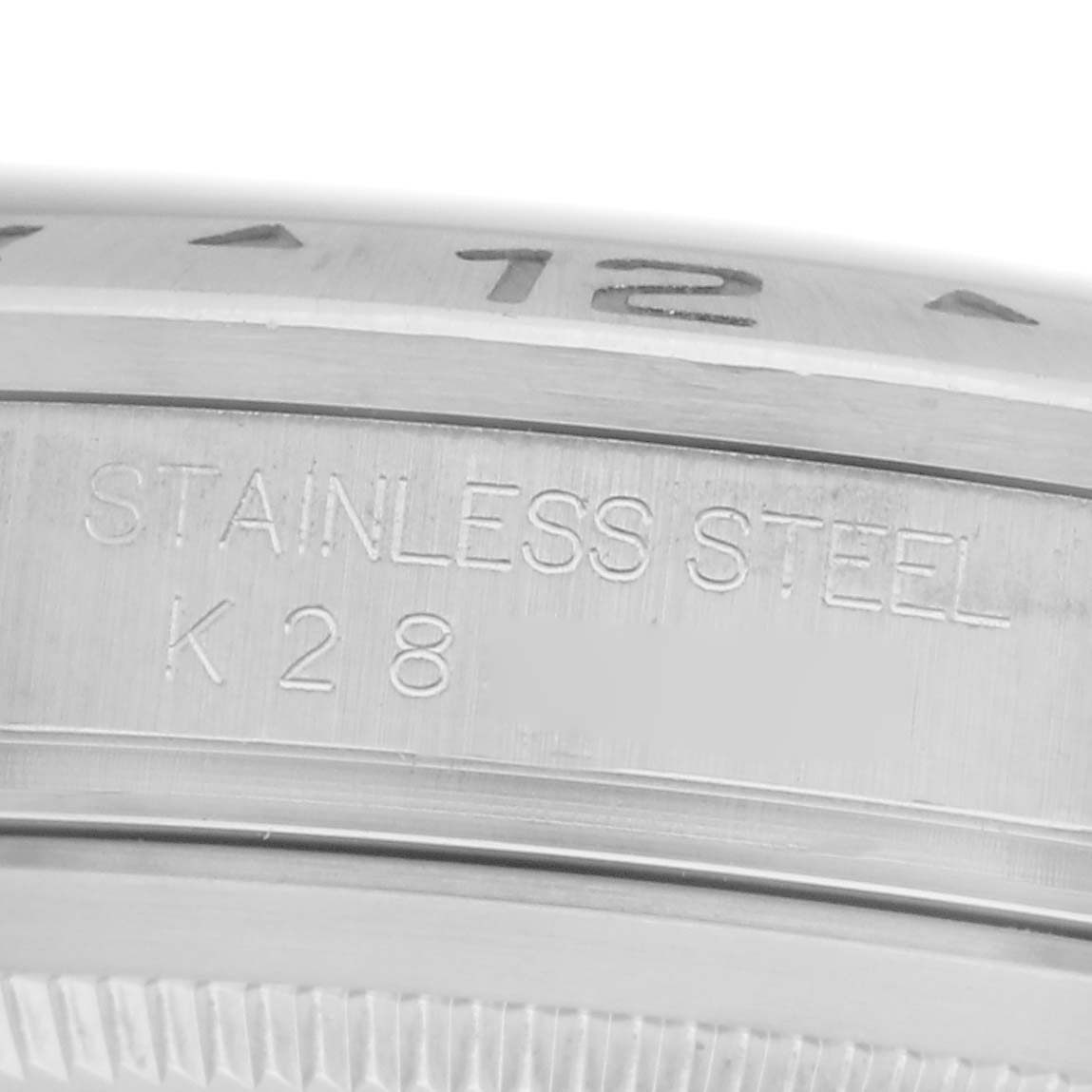 The image shows a close-up of the side of a stainless steel Rolex Explorer, model number 16570, highlighting part of the bezel with engraved numerals.