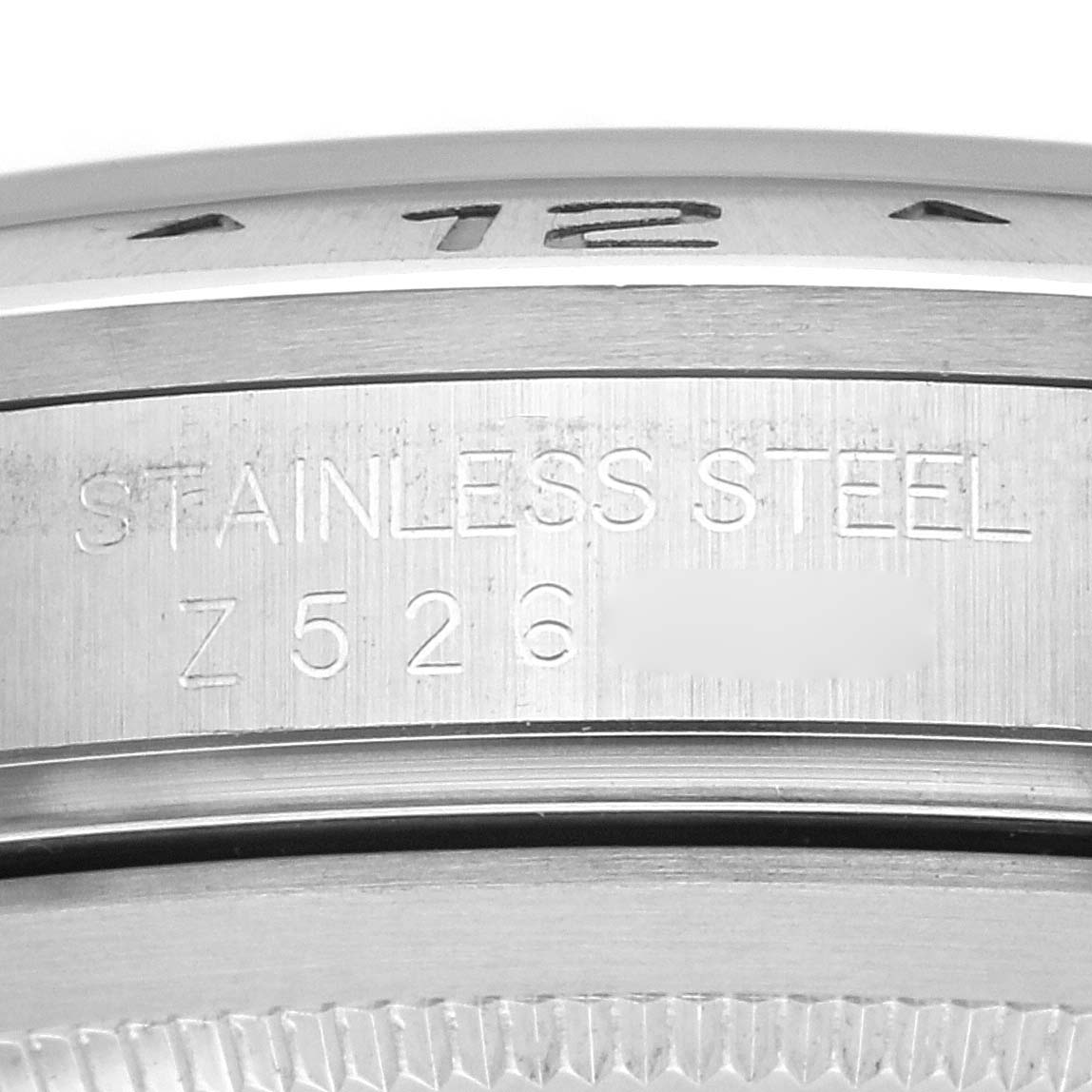 The image shows a close-up angle of a Rolex Explorer model 16570, focusing on the engraved stainless steel side with part of the bezel visible.