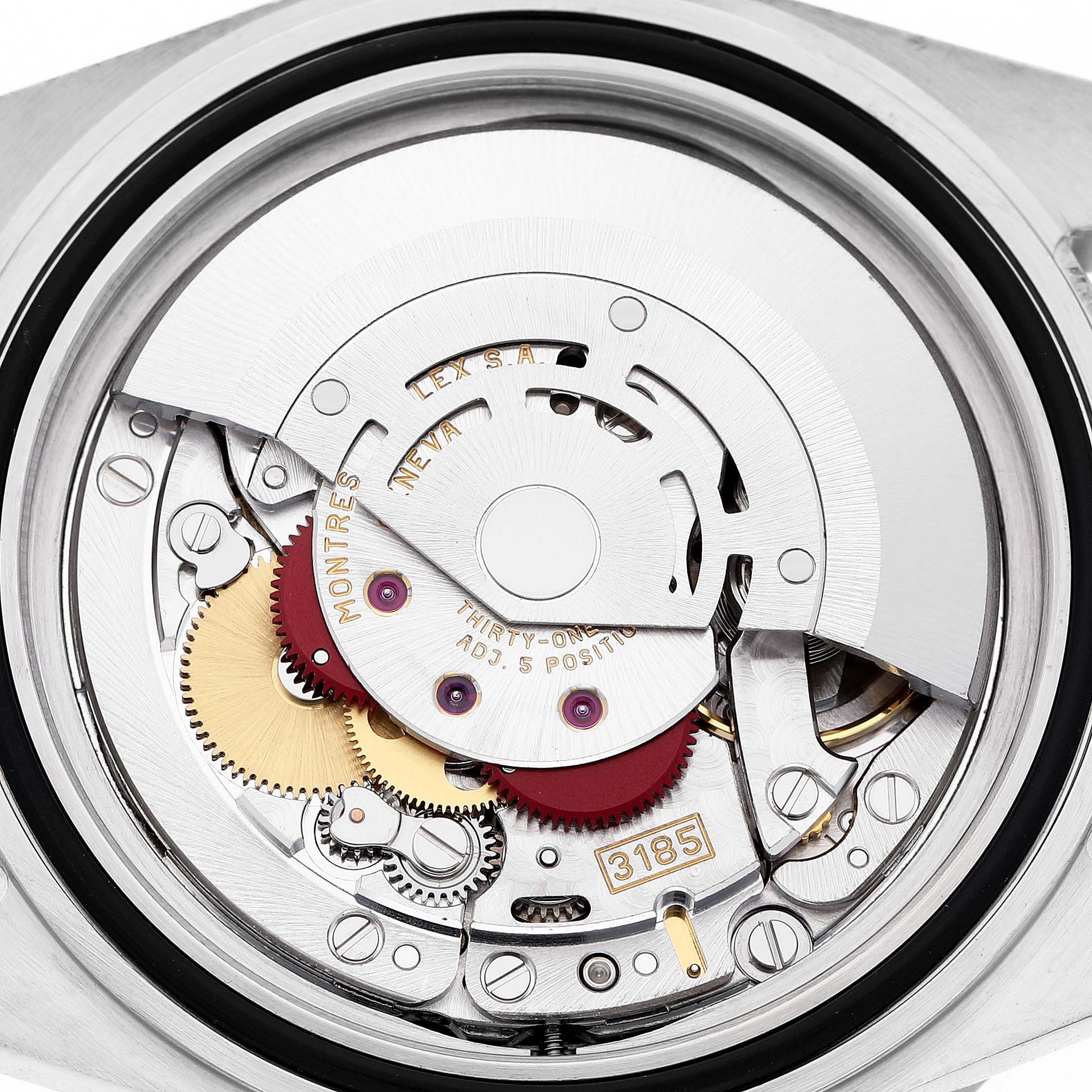 The image shows the detailed view of the movement inside the Rolex GMT-Master 16713 Men's Stainless Steel Champagne Dial, focusing on the intricate components and gears.