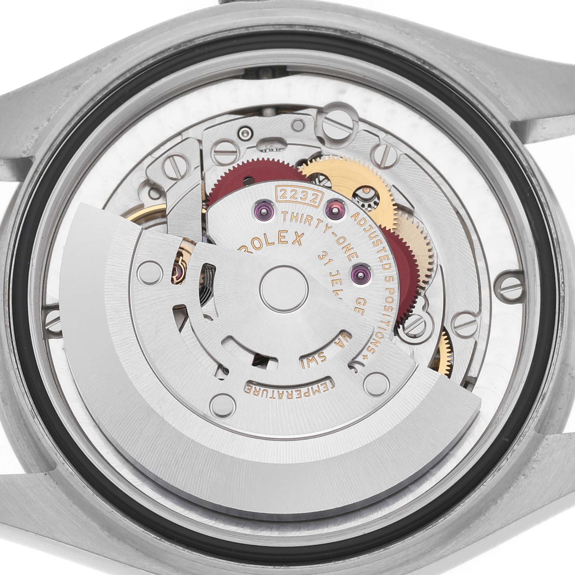 The image shows the internal mechanism of a Rolex Mid-Size 277200 Women's Stainless Steel Pink Dial model watch from a rear angle, highlighting the rotor and gears.