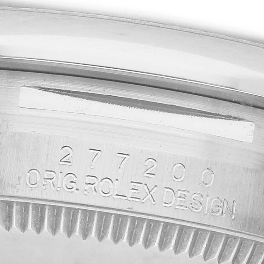 The image shows a close-up of the outer bezel and engraved serial number of a Rolex Mid-Size 277200 Women's Stainless Steel Pink Dial watch.