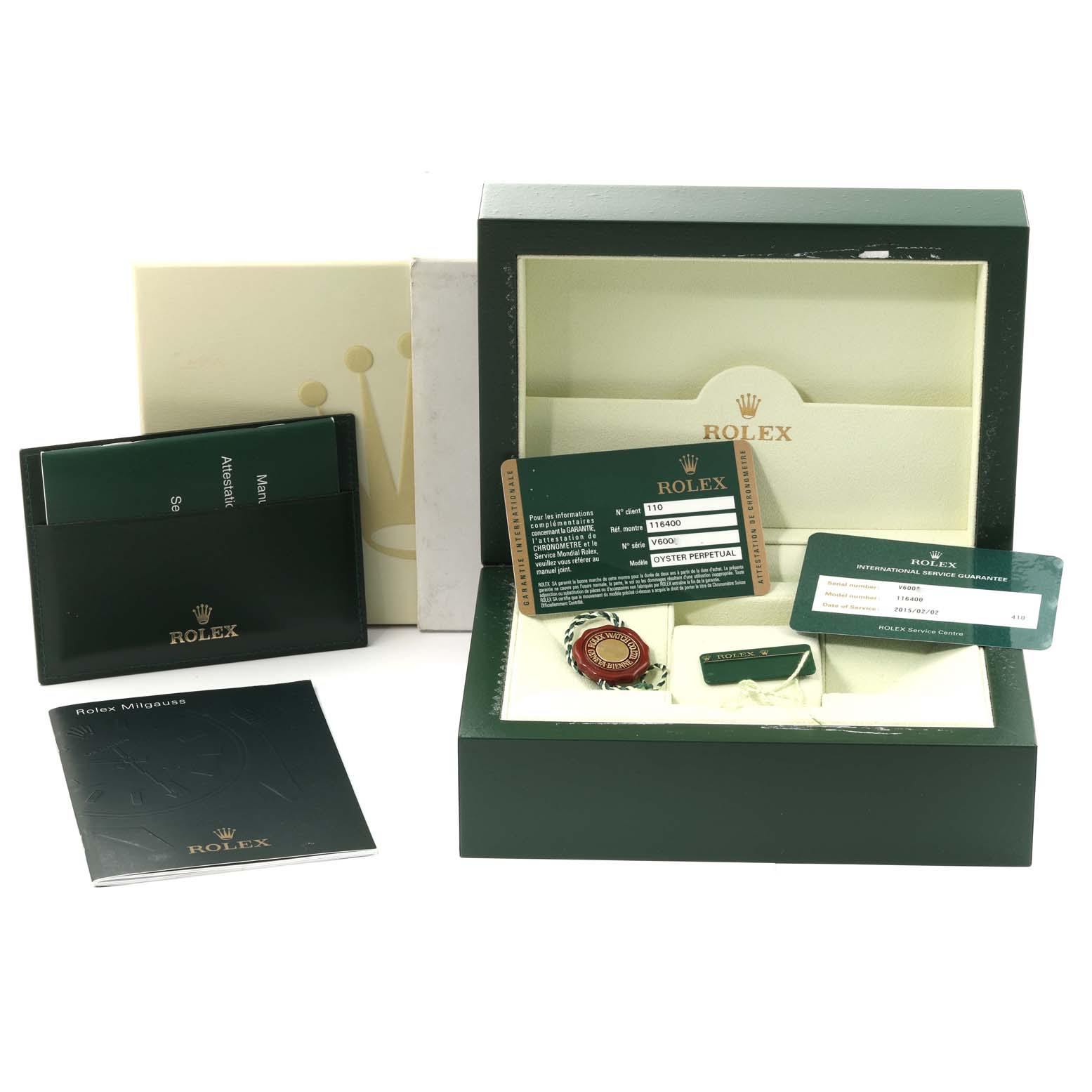 The image shows the Rolex Milgauss 116400 Men's Stainless Steel White Dial 116400 Men's Stainless Steel White Dial watch box, warranty cards, manuals, and various accessories from a frontal angle.