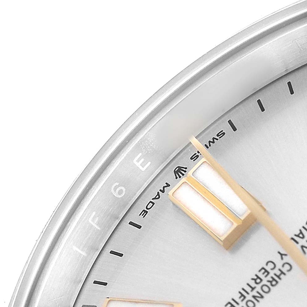 The image shows a close-up of the Rolex Oyster Perpetual 124300 Men's Stainless Steel Silver Dial watch face, highlighting the hour markers, hands, and part of the bezel.
