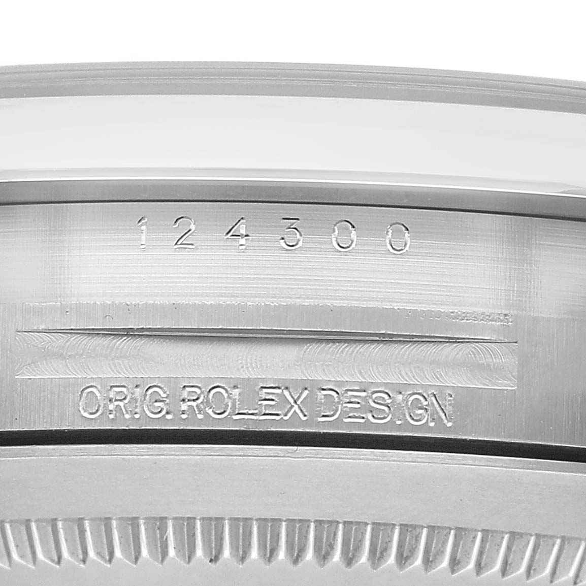 The image shows a close-up of the case-back edge engraving of a Rolex Oyster Perpetual 124300 Men's Stainless Steel Silver Dial, featuring the model number and "ORG. ROLEX DESIGN."