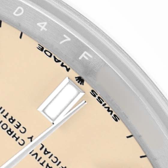 The image shows a close-up of a Rolex Mid-Size 277200 Women's Stainless Steel Beige Dial model, highlighting part of the dial, hour marker, and text.
