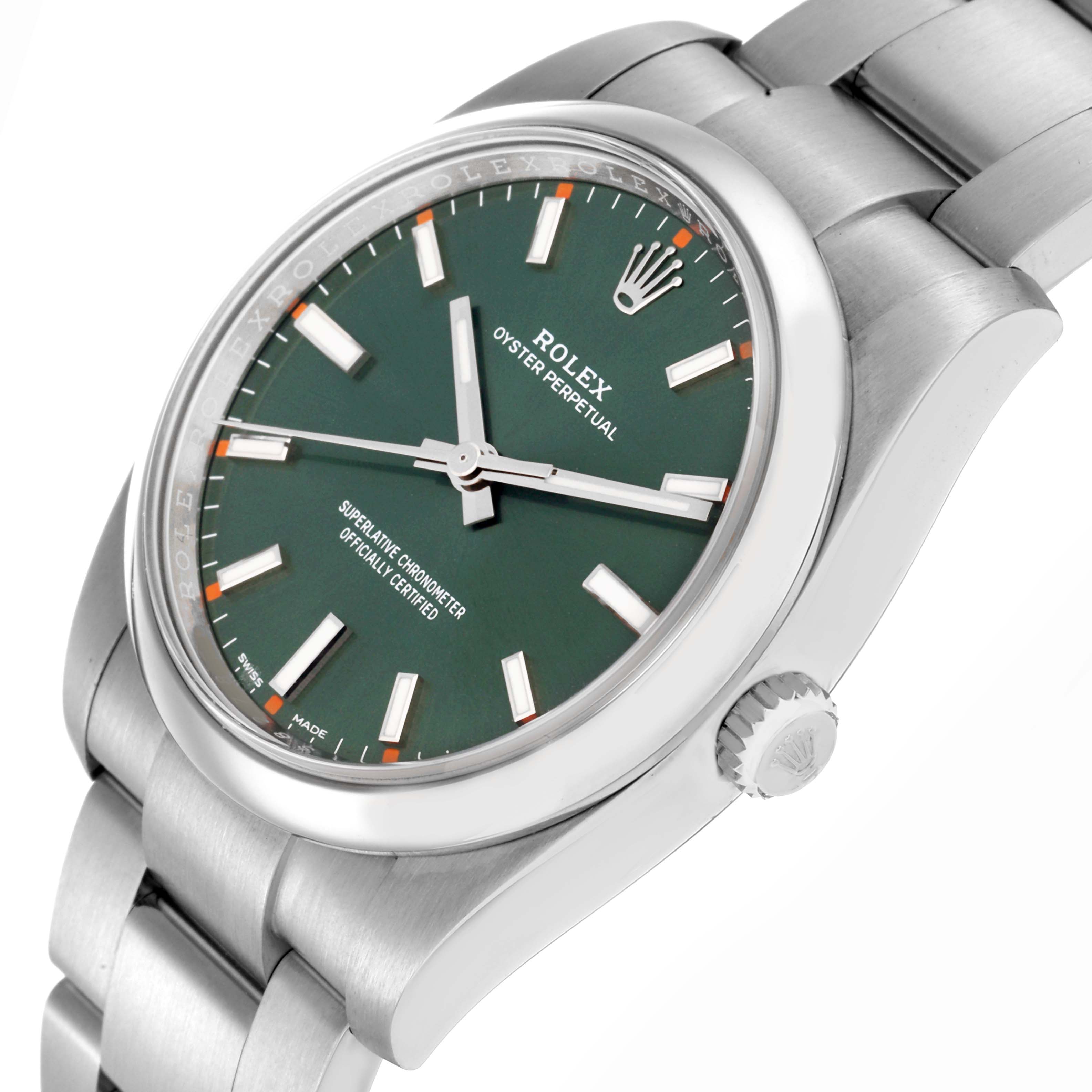 The image shows a Rolex Oyster Perpetual model 114200 with a green dial, viewed from a slight angle highlighting the dial, crown, and part of the bracelet.