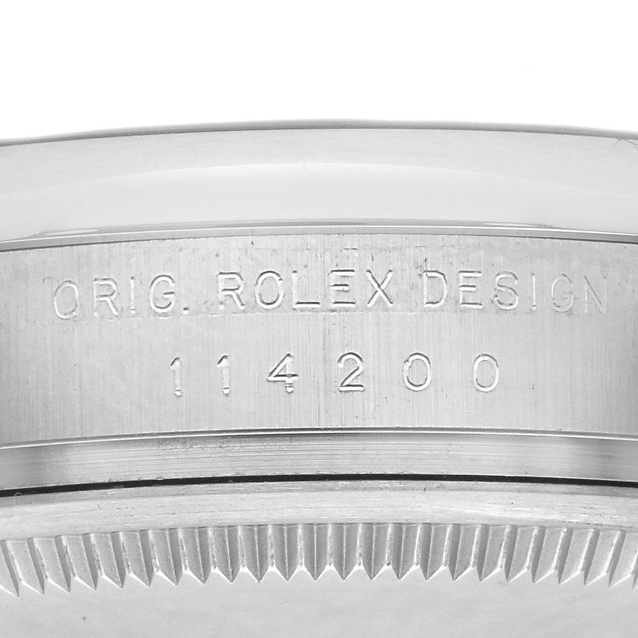 The image shows a close-up side view of a Rolex Oyster Perpetual, model number 114200, focusing on the engraved watch case.