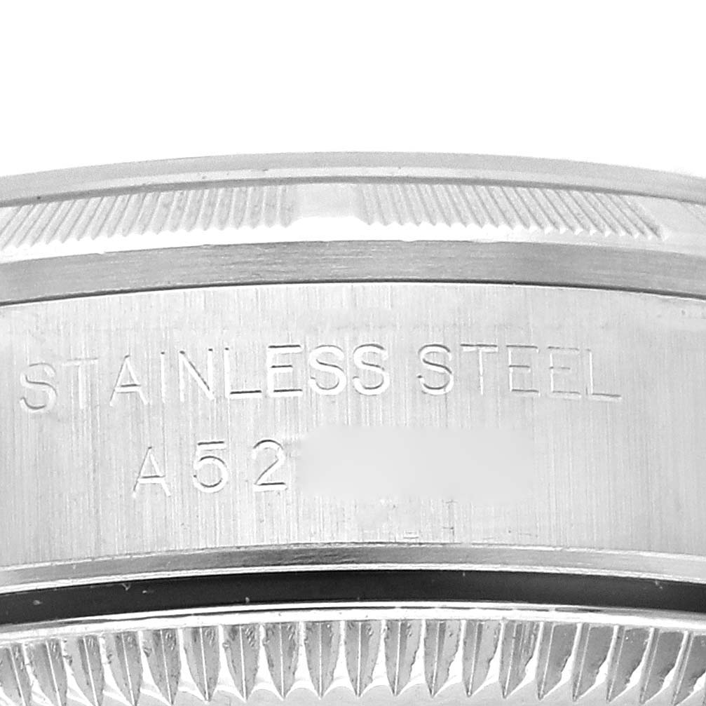 This image shows a close-up view of the stainless steel bezel and case back of a Rolex Oyster Perpetual 76030 Women's Stainless Steel Pink Dial 76030 Women's Stainless Steel Pink Dial watch.