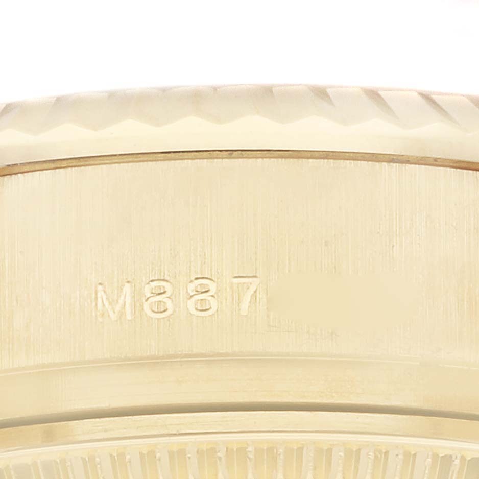 The image shows a close-up angle of the side of a Rolex President 179178 Women's Yellow Gold Champagne Dial 179178 Women's Yellow Gold Champagne Dial model watch, highlighting the engraved serial number.