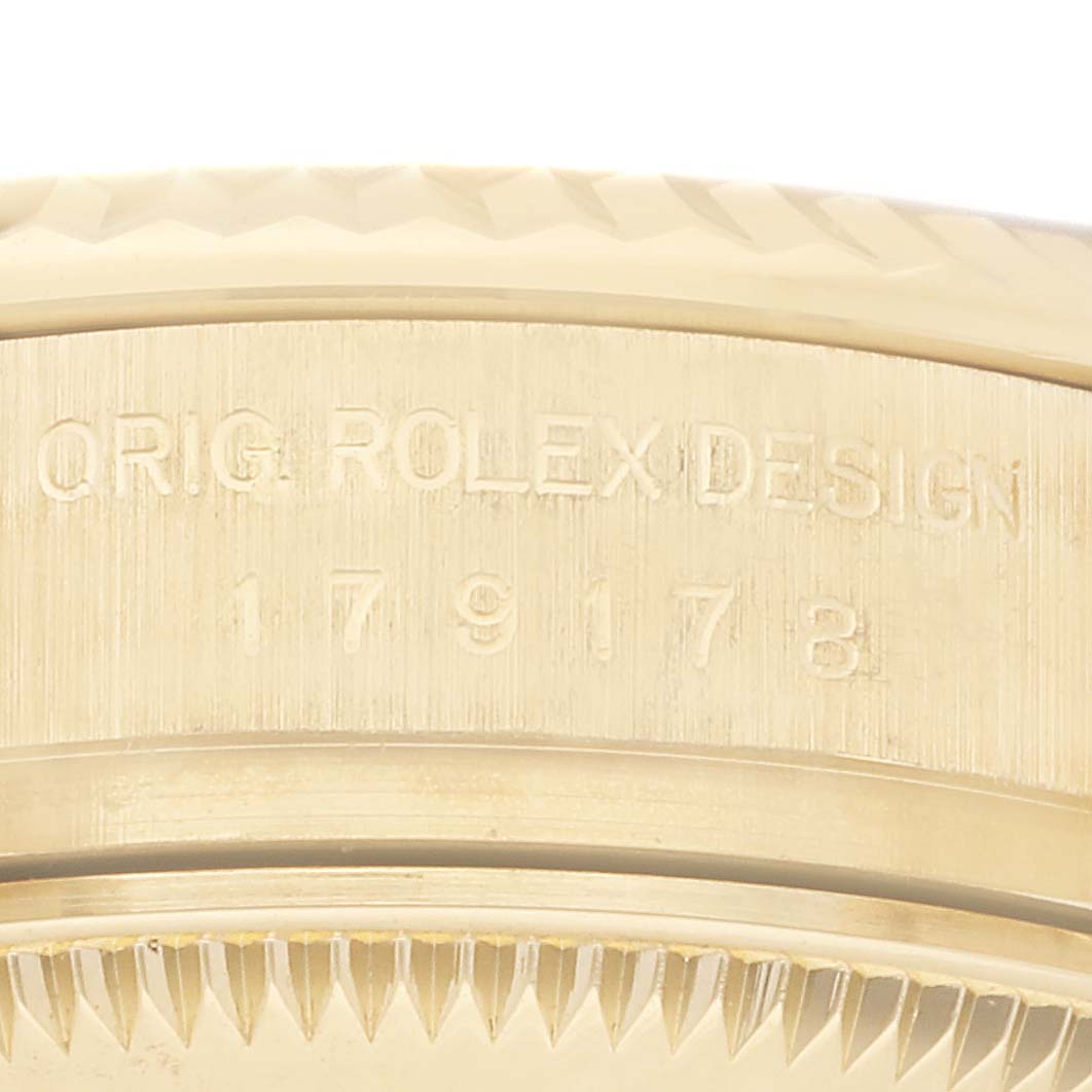 This close-up image shows the bezel edge and model engraving of a Rolex President 179178 Women's Yellow Gold Champagne Dial 179178 Women's Yellow Gold Champagne Dial watch.
