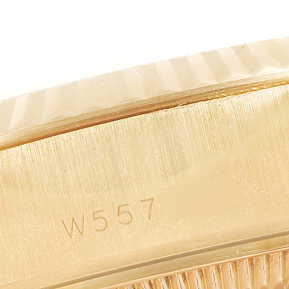 This is a close-up image showing the serial number engraving on the case of a Rolex President 69178 Women
s Yellow Gold Champagne Dial 69178 Women
s Yellow Gold Champagne Dial model watch.