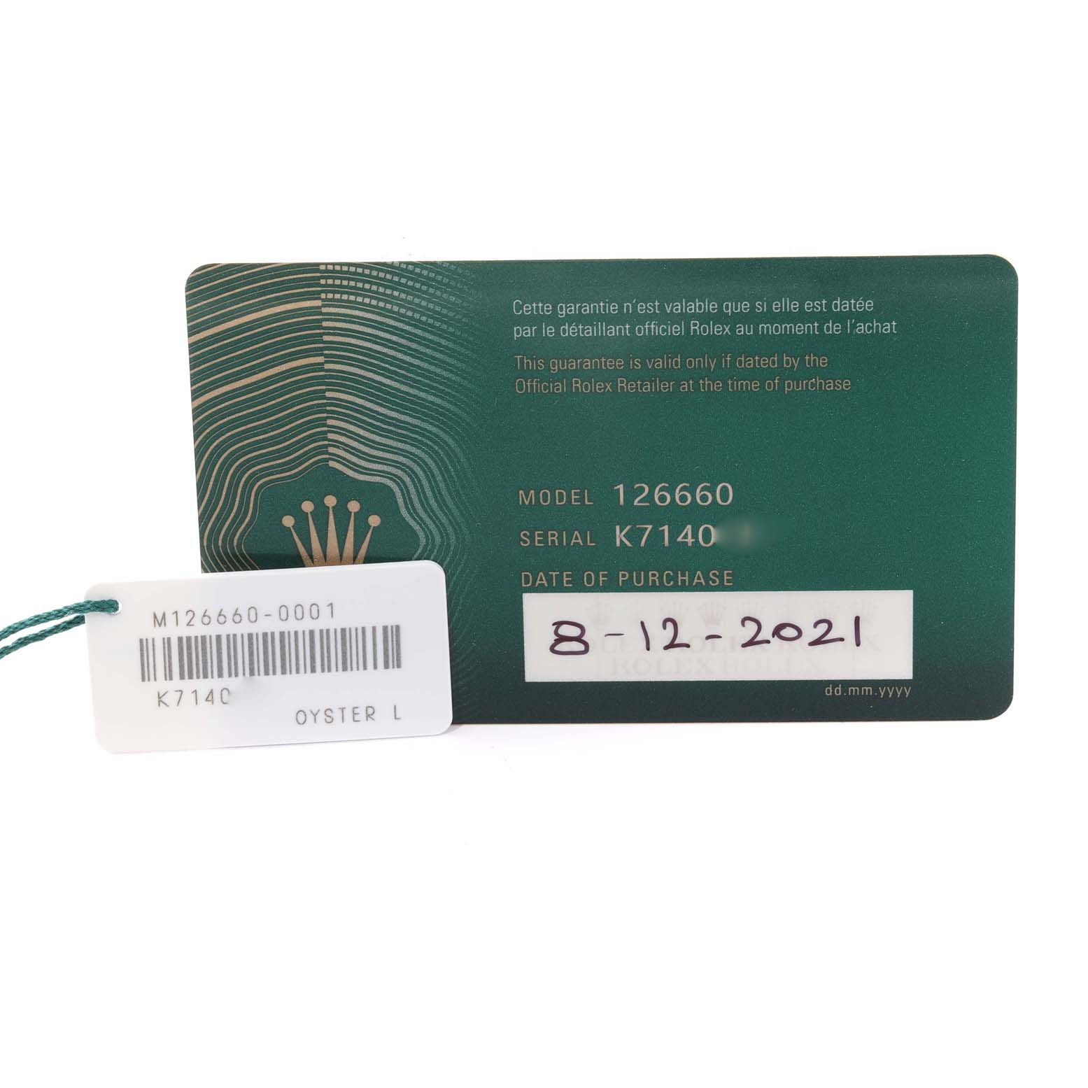 The image shows the warranty card and tags for the Rolex Sea-Dweller 126660 Men
s Stainless Steel Black Dial 126660 Men
s Stainless Steel Black Dial model 126660.