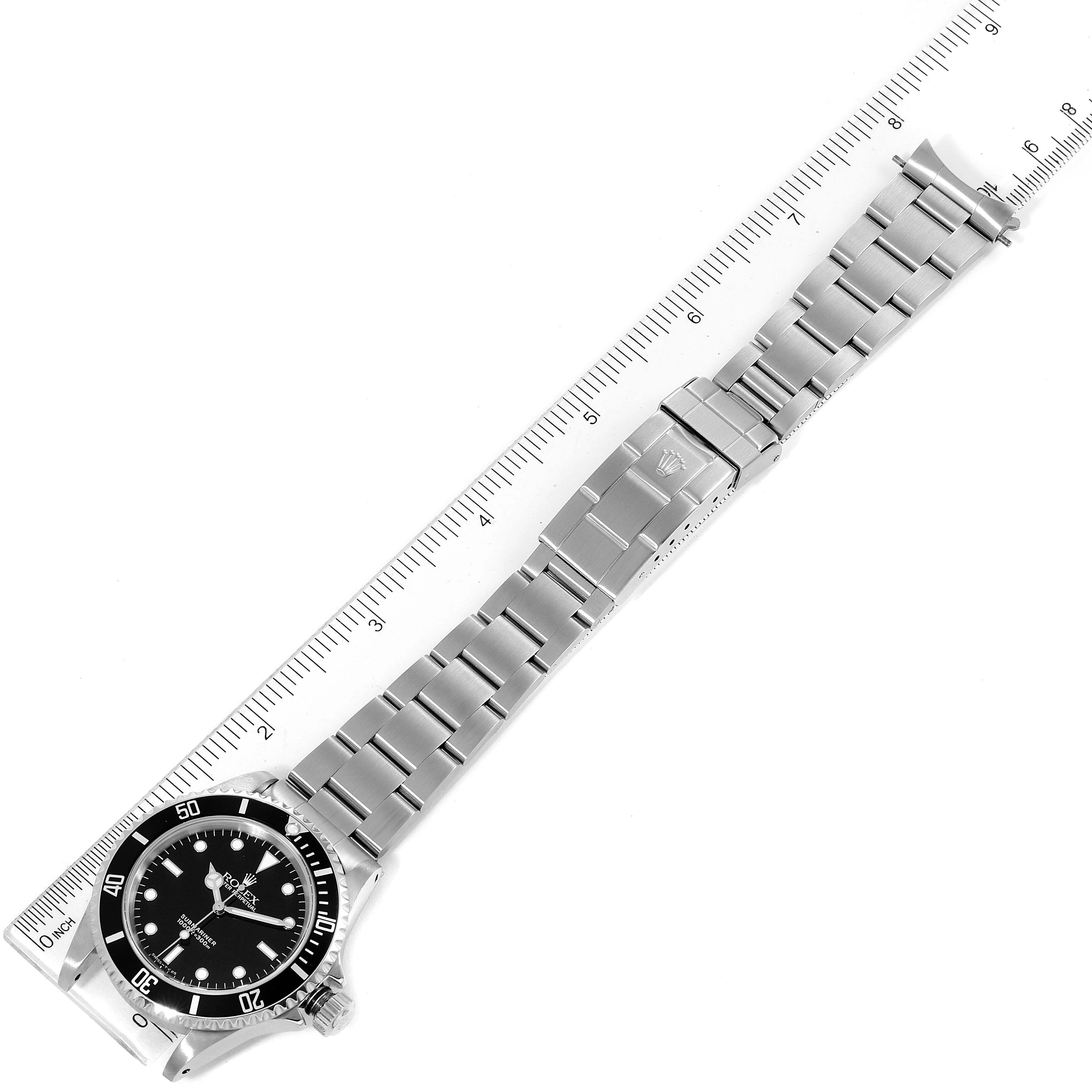 The image shows a top-down view of a Rolex Submariner 14060 Men
s Stainless Steel Black Dial 14060 Men
s Stainless Steel Black Dial watch, displaying the face and full metal bracelet alongside a ruler.
