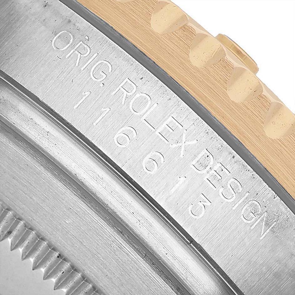 The image shows a close-up of the side of a Rolex Submariner 116613LN Men's Steel and Gold (two tone) Black Dial, highlighting the engraved model number and edge details.