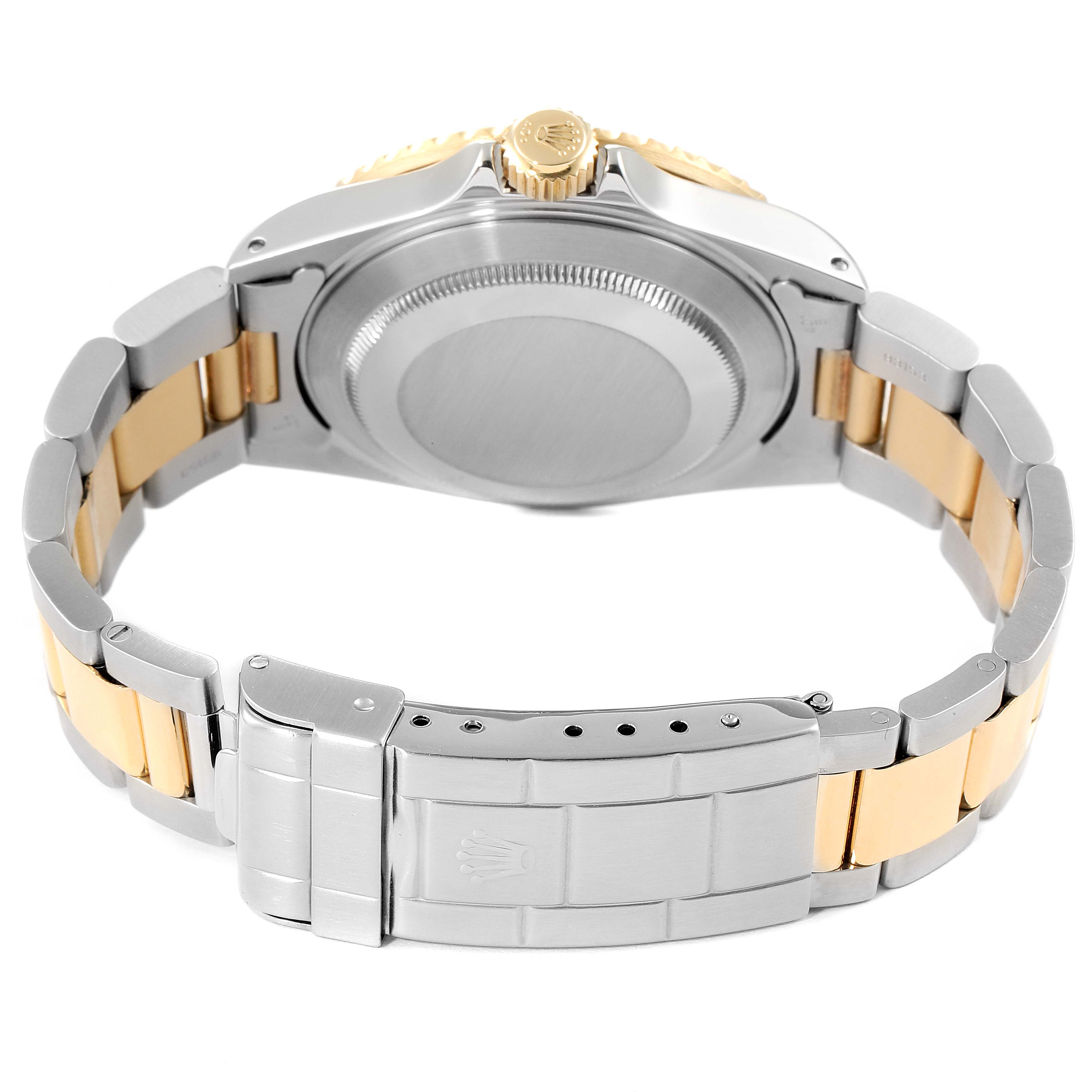 The image shows a rear view of the Rolex Submariner 16613 Men's Steel and Gold (two tone) Blue Dial 16613 Men's Steel and Gold (two tone) Blue Dial, highlighting the case back, crown, and two-tone bracelet with clasp.