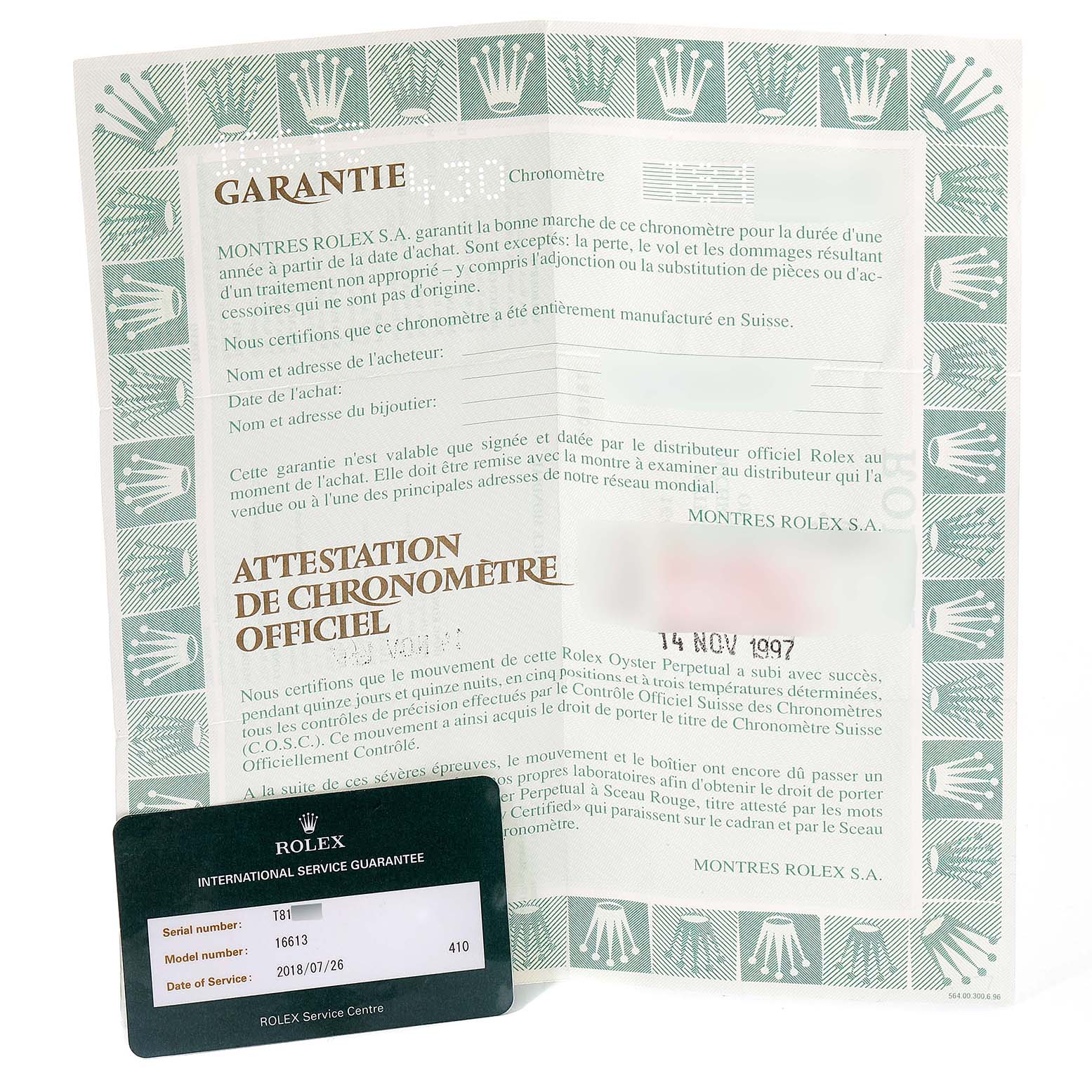 The image shows warranty paperwork and an international service guarantee card for the Rolex Submariner 16613 Men's Steel and Gold (two tone) Blue Dial 16613 Men's Steel and Gold (two tone) Blue Dial model.