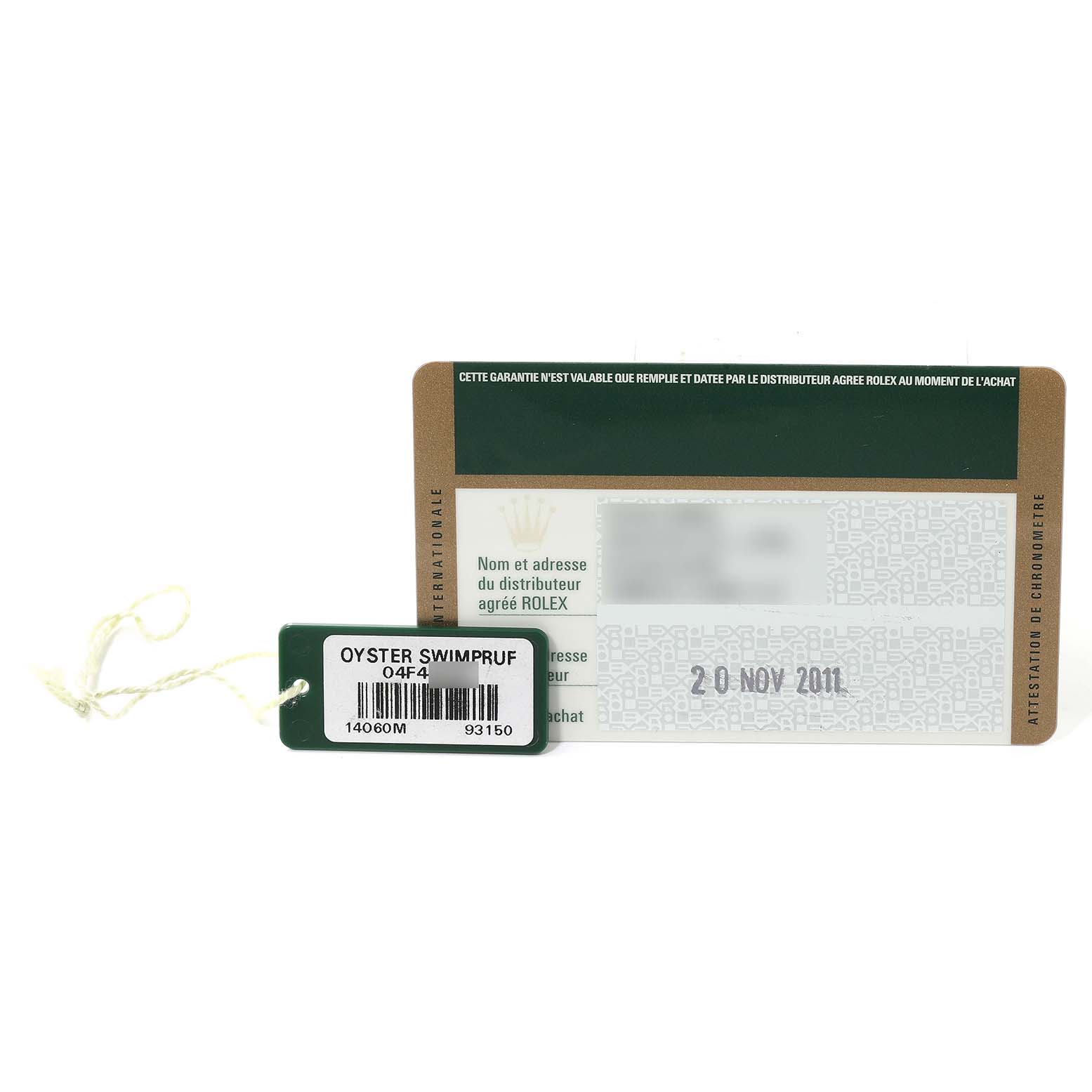 The image shows a warranty card and a tag for a Rolex Submariner 14060 Men
s Stainless Steel Black Dial 14060 Men
s Stainless Steel Black Dial watch placed side by side.