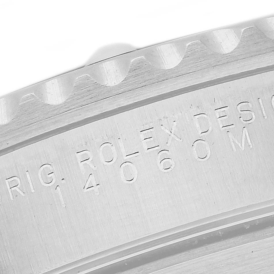 This image shows a close-up of the engraved bezel and case side of a Rolex Submariner 14060 Men
s Stainless Steel Black Dial 14060 Men
s Stainless Steel Black Dial model watch.