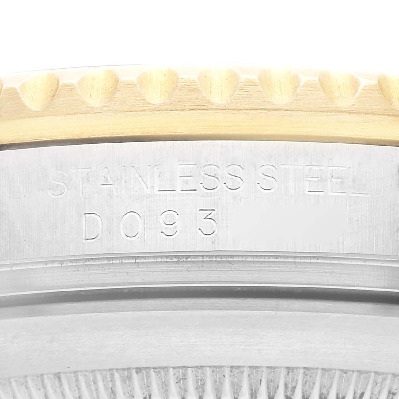This image shows a close-up view of the bezel and case of a Rolex Submariner 16613 Men's Steel and Gold (two tone) Black Dial 16613 Men's Steel and Gold (two tone) Black Dial watch, highlighting the engraving "STAINLESS STEEL."