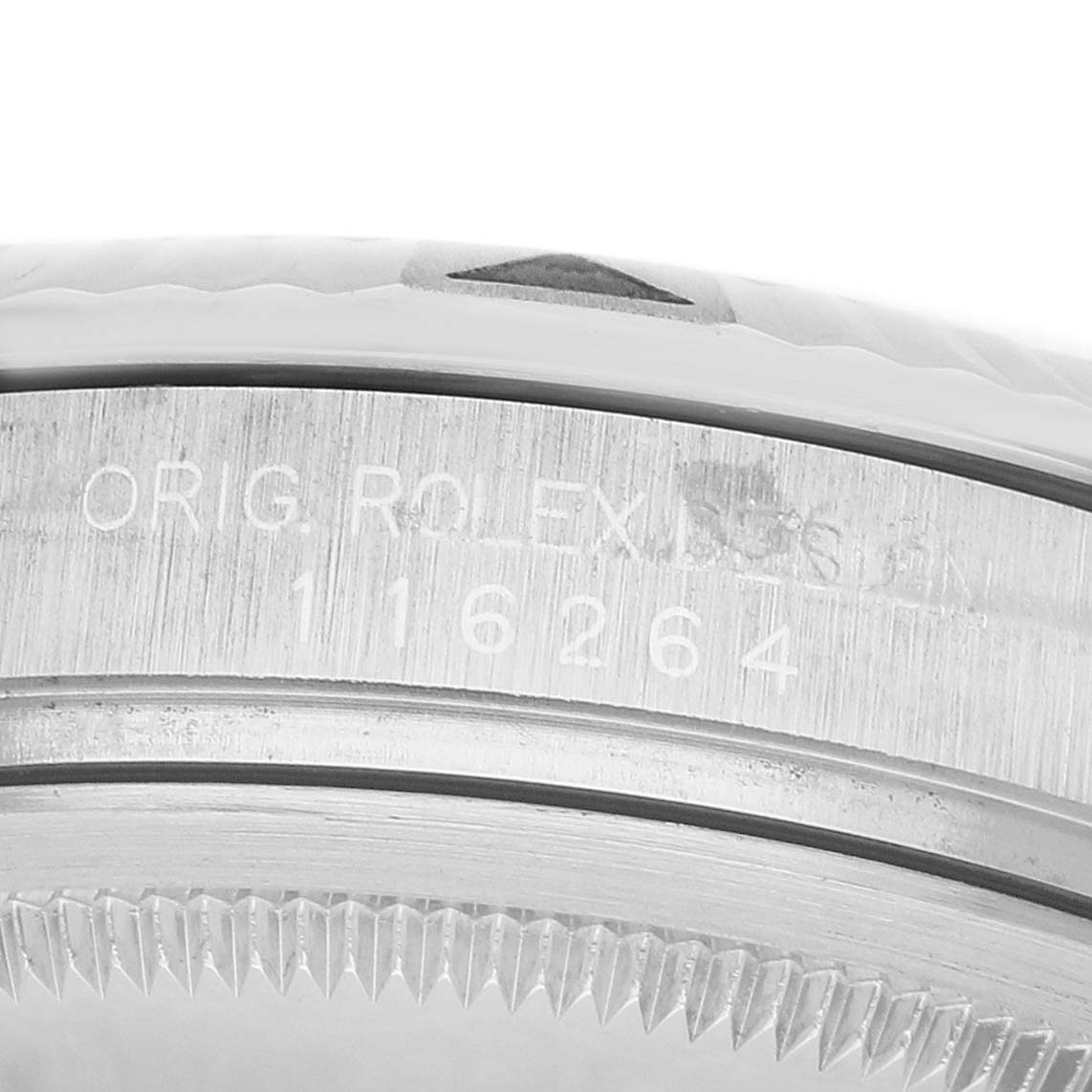 The image shows a close-up of the side of a Rolex Turn-o-Graph 116264 Men's Stainless Steel White Dial watch, focusing on the bezel and engraved serial details.