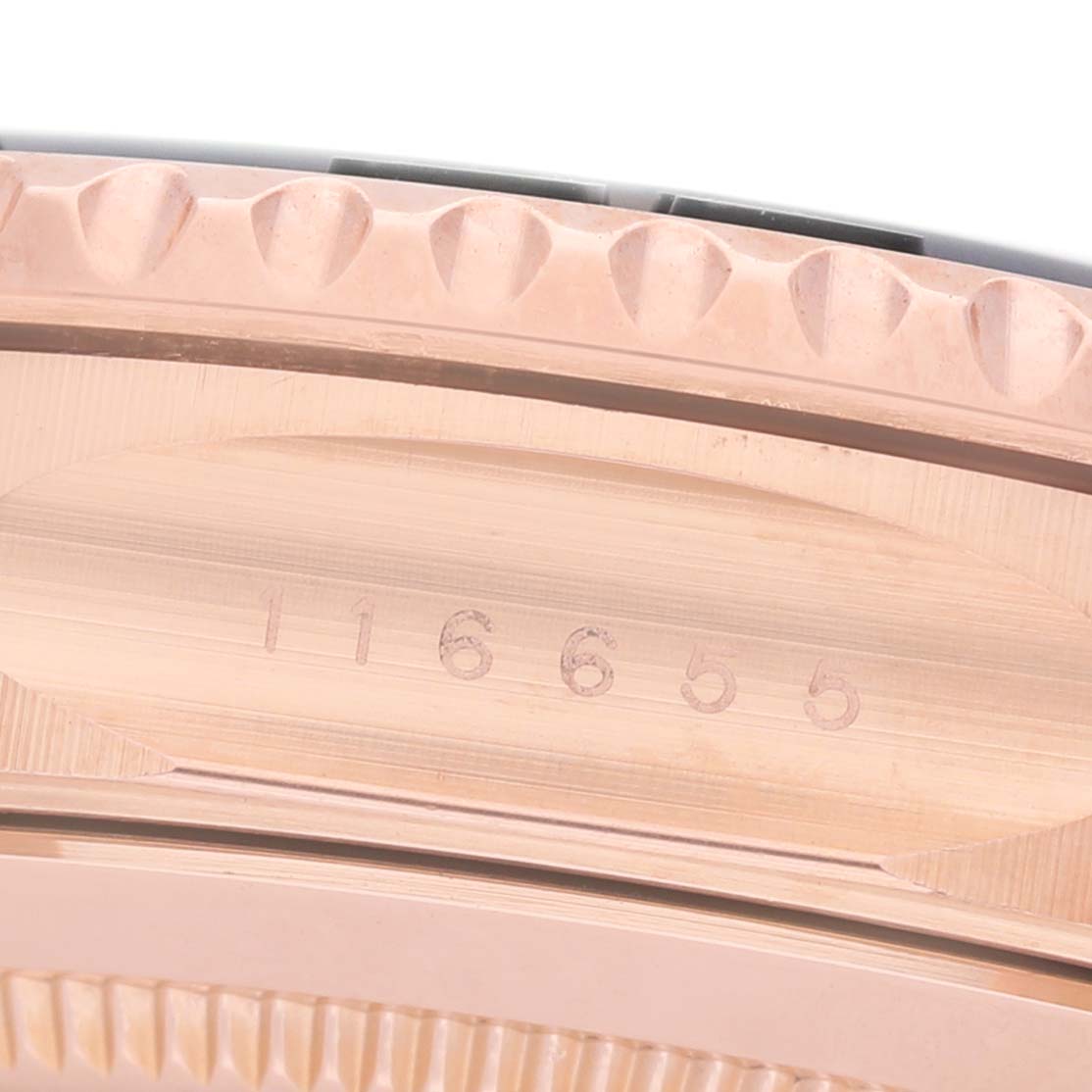 The image shows a close-up of the Rolex Yacht-Master 116655 Men's Rose Gold Black Dial's side, detailing the edged bezel and engraved serial number.