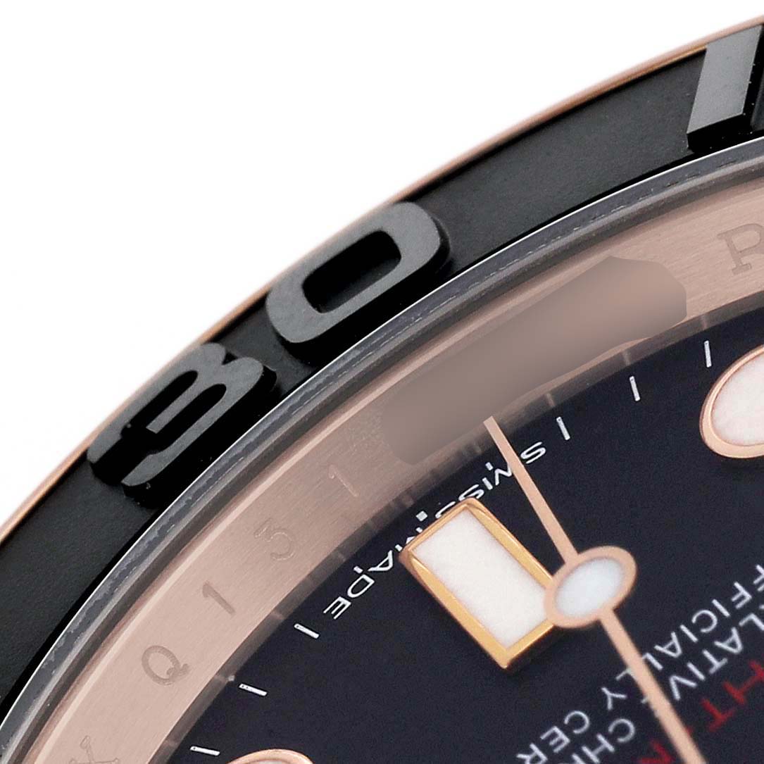 The image shows a close-up of the bezel and dial of a Rolex Yacht-Master 116655 Men's Rose Gold Black Dial watch, highlighting the hour markers and part of the bezel.