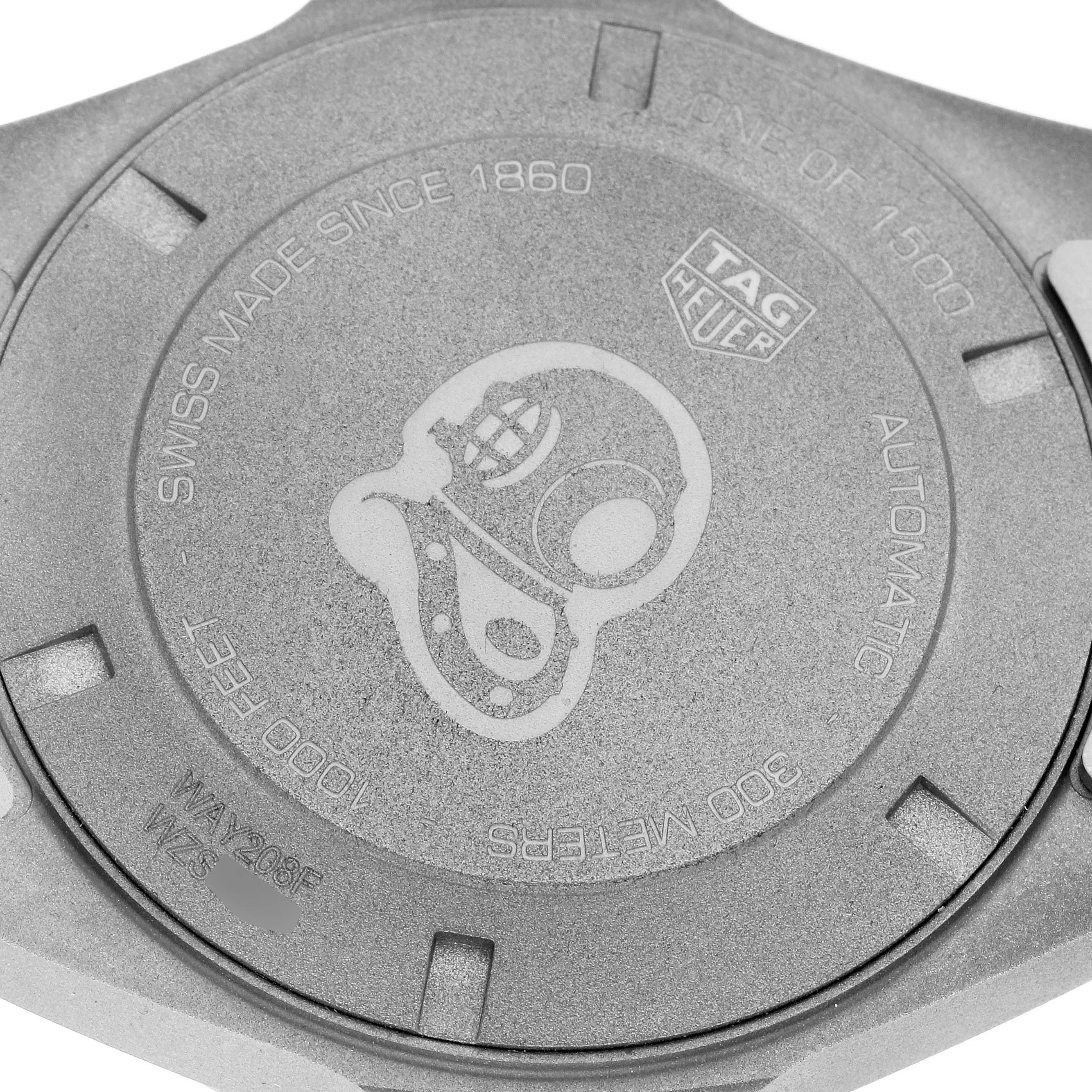 The image shows the back of the Tag Heuer Aquaracer model WAY208F.BF0638, featuring an engraved diving helmet design and model details.