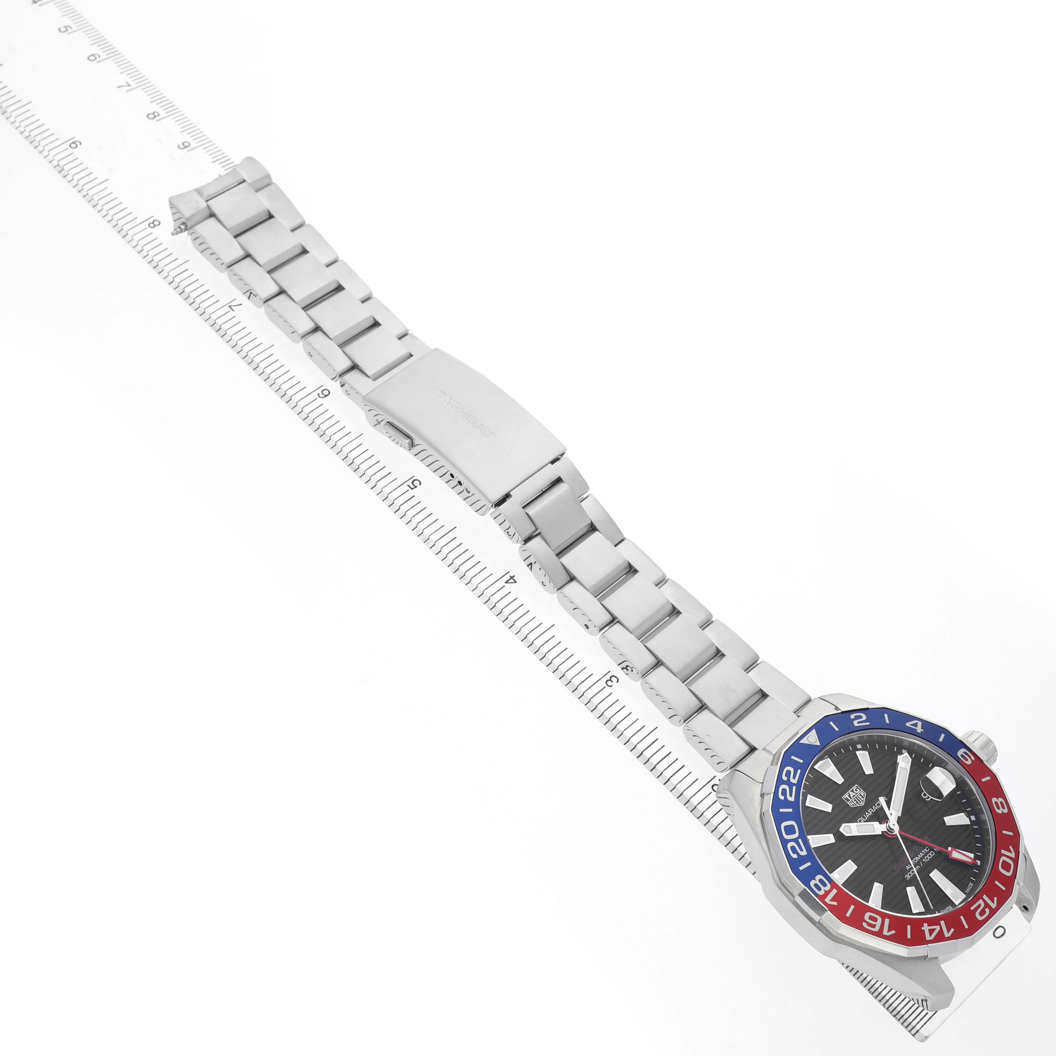 The Tag Heuer Aquaracer WAY201F.BA0927 Men's Stainless Steel Black Dial watch is shown at an angled top view, displaying the face, bezel, and metal bracelet with a ruler for scale.