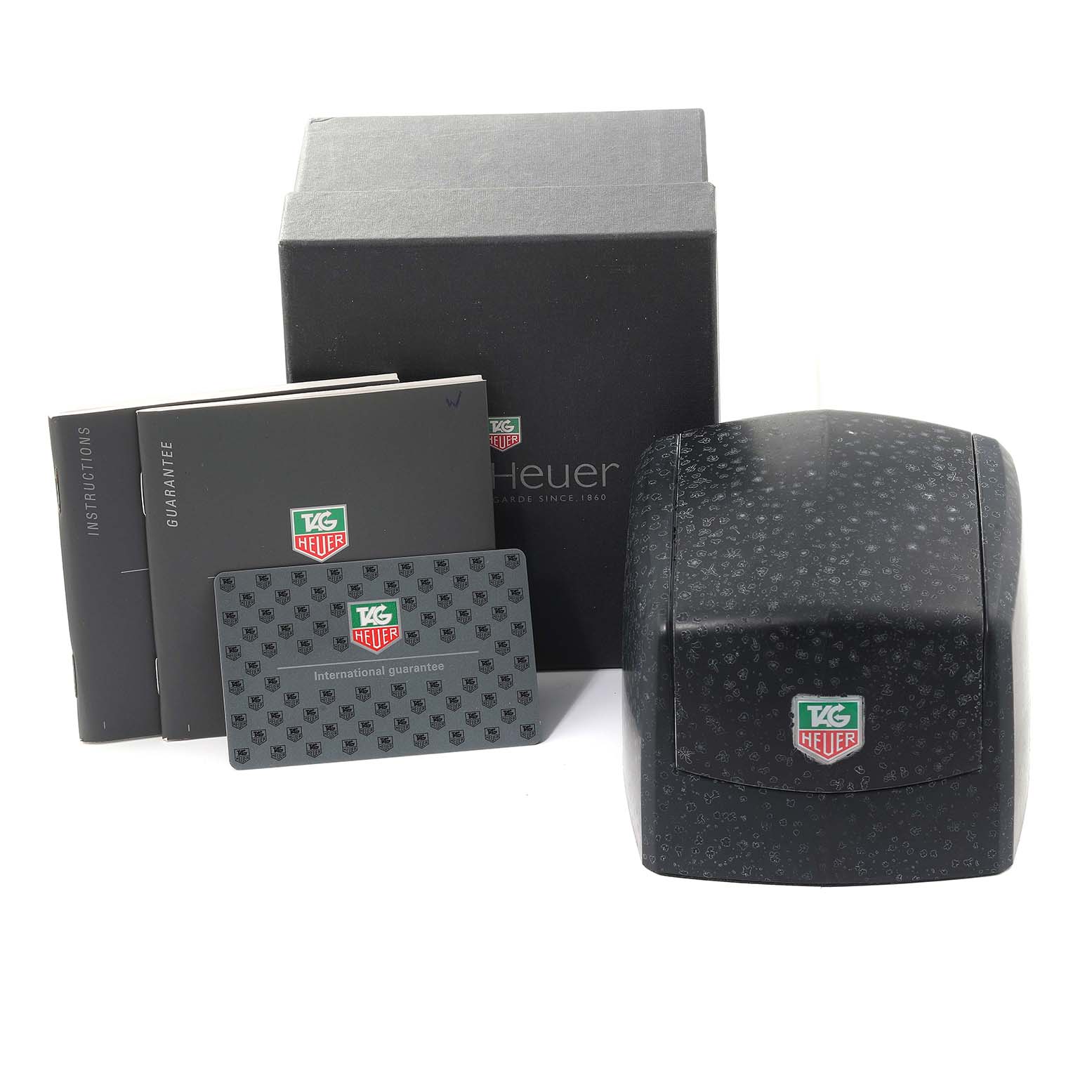 The image shows the box, case, instruction booklet, guarantee booklet, and international guarantee card for a Tag Heuer Autavia CY2110 Men's Stainless Steel White Dial CY2110 Men's Stainless Steel White Dial watch.