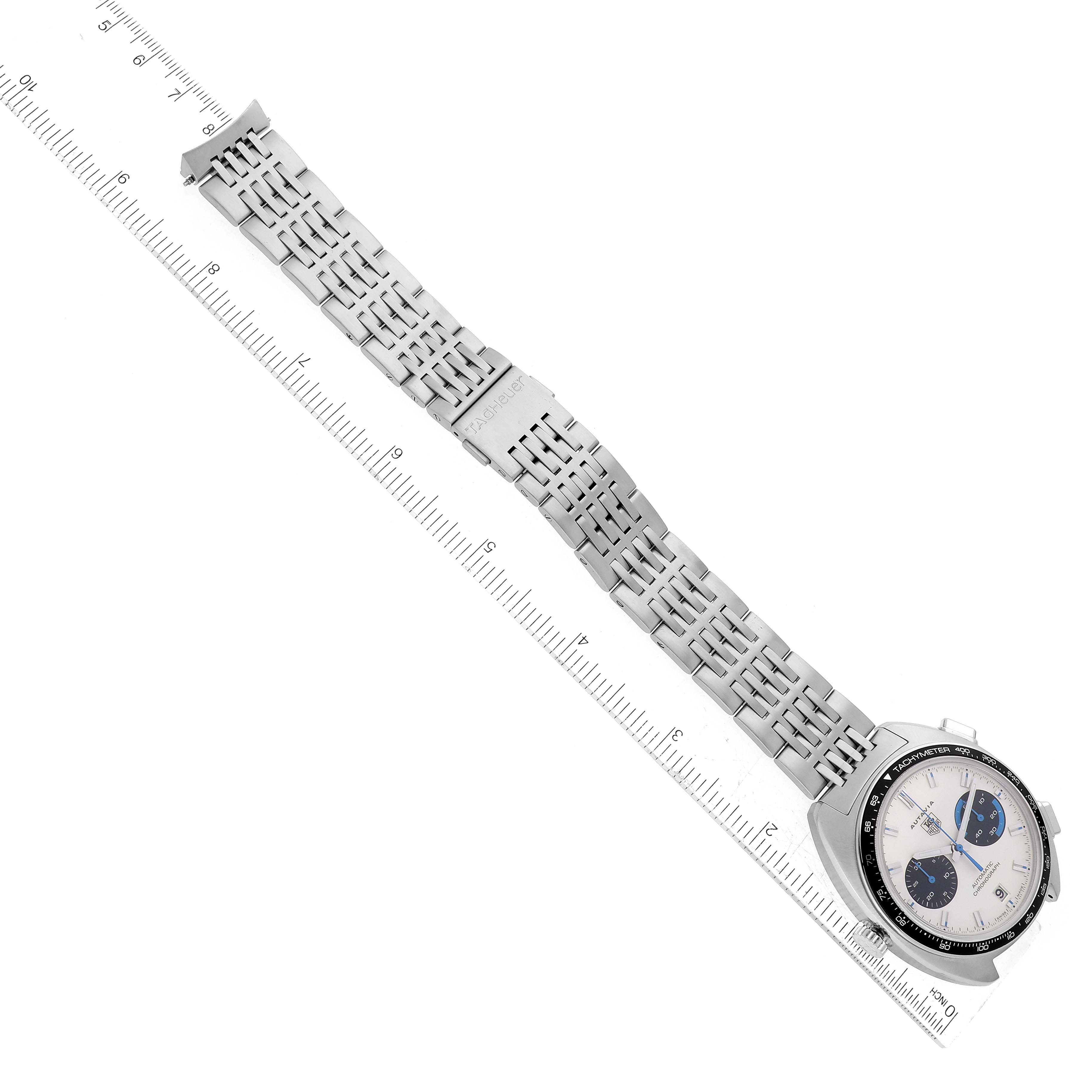 The image shows a Tag Heuer Autavia CY2110 Men's Stainless Steel White Dial CY2110 Men's Stainless Steel White Dial watch from a top-down angle, focusing on its bracelet and watch face.