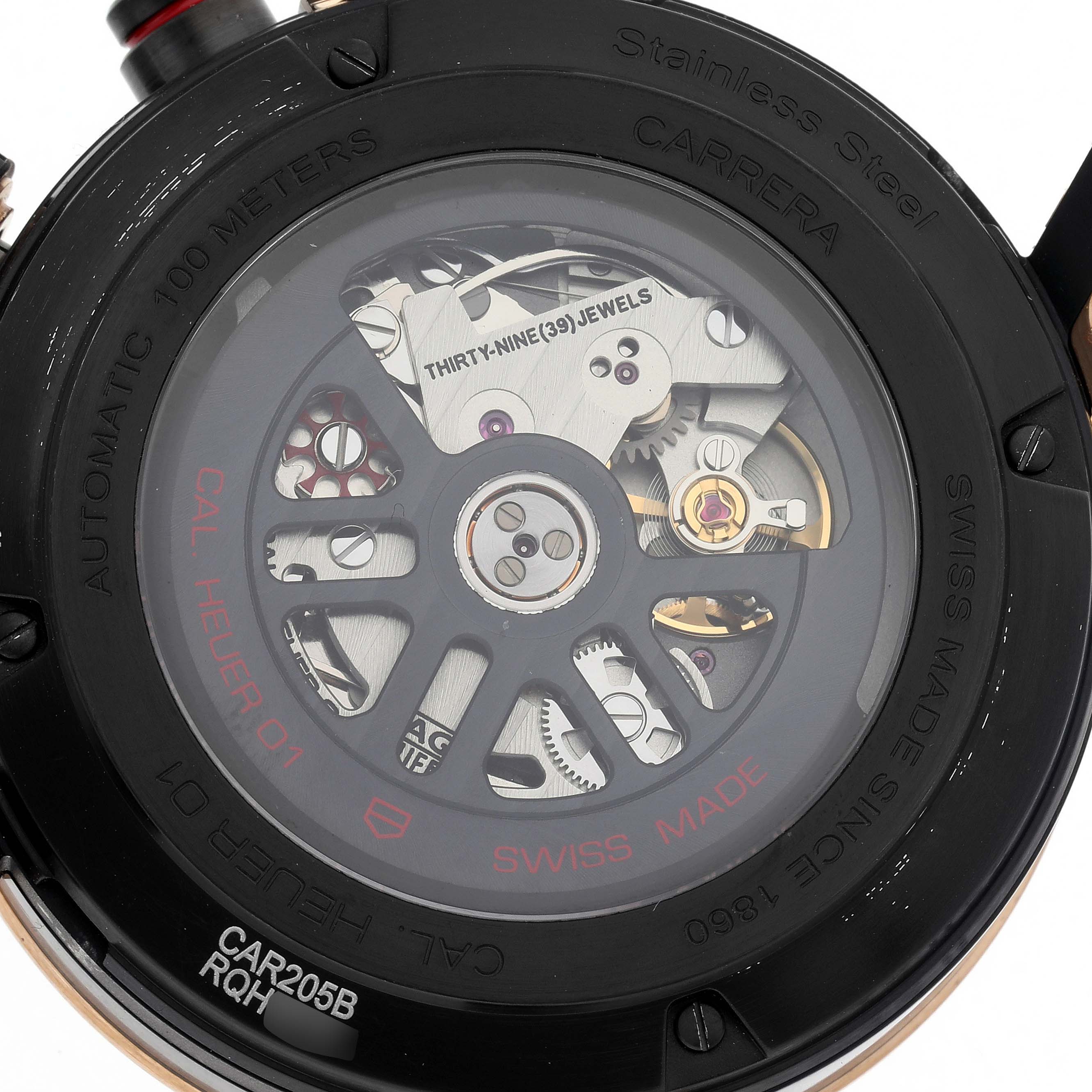 The image shows the back of a Tag Heuer Carrera men's watch, model CAR205B, highlighting its automatic movement and jewel details.
